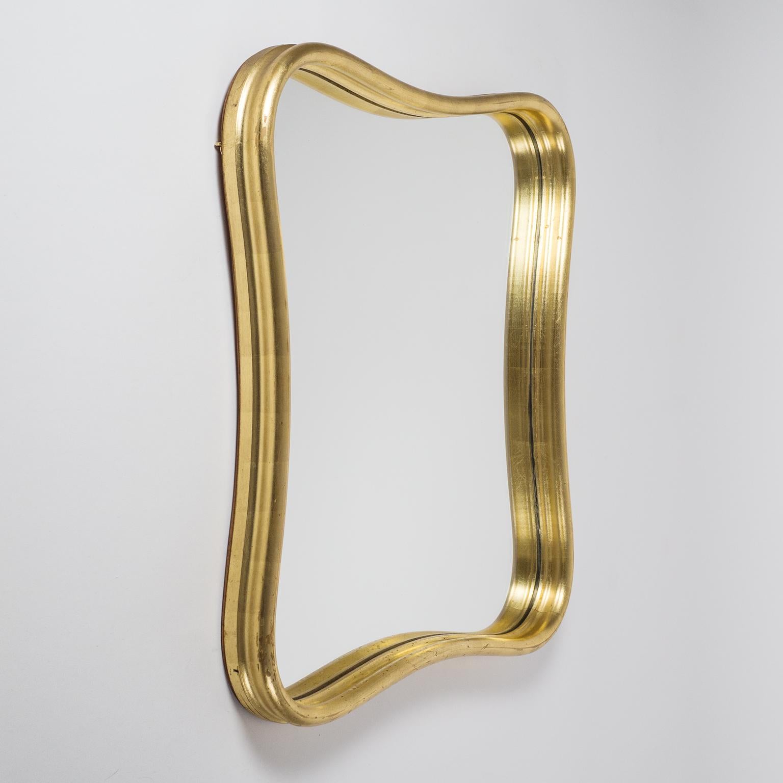 Lovely Austrian giltwood mirror from the 1940s. Sensuously curved frame with a rounded profile and gold leaf finish. Fine original condition with some light wear to the gold leaf.