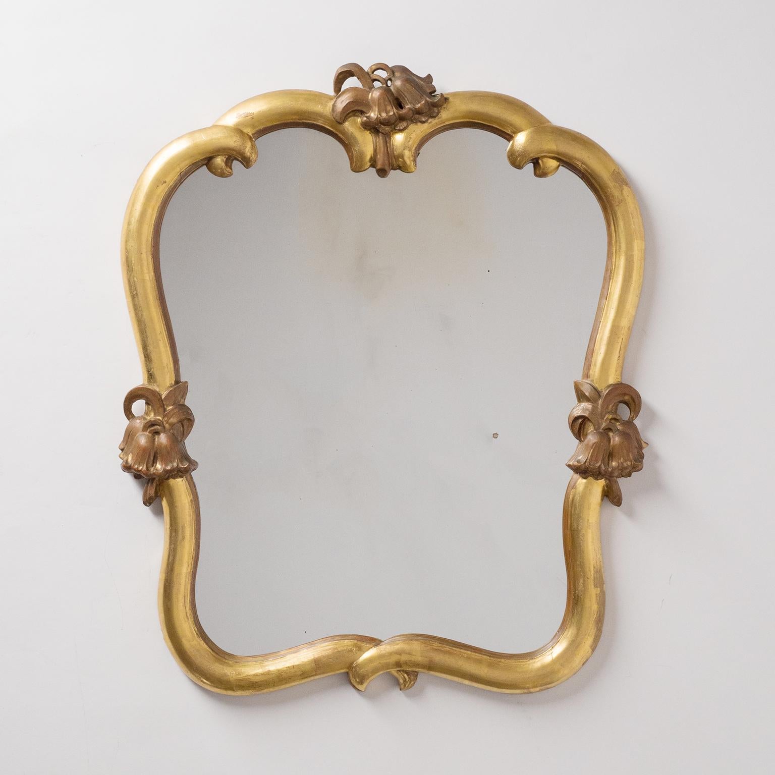 Rare pair of giltwood mirrors by Max Welz, circa 1930. Carved limewood with leaf gold and floral decorations - noteworthy is that the floral decor on the top are mirrored. Very good condition (previously retored frames and backplate) with original