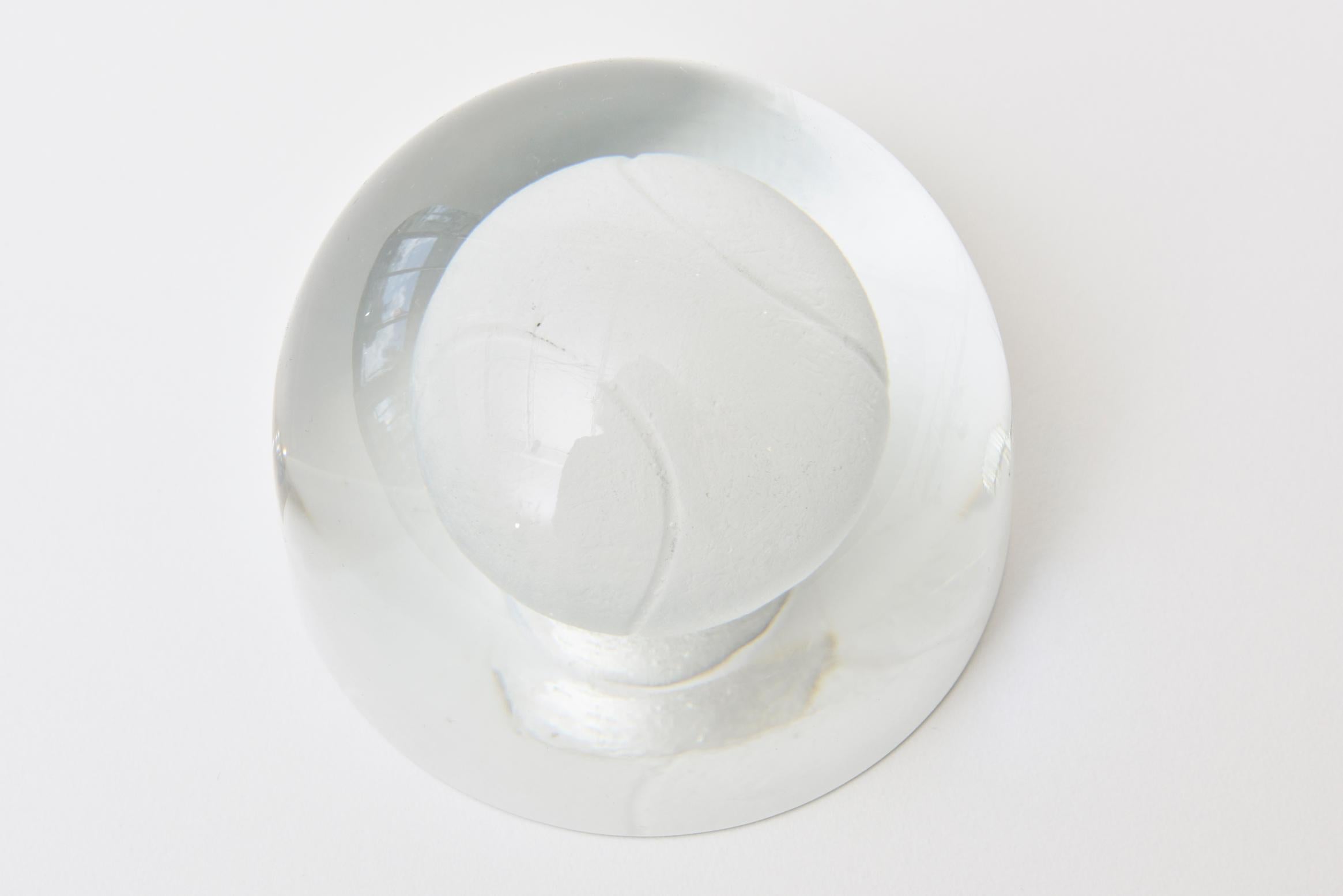For all the tennis lovers and players, this great Austrian dome like clear glass tennis ball paperweight is a great desk accessory. There is a mini version of the tennis ball embedded in the glass and is more of frosted style glass tennis ball with