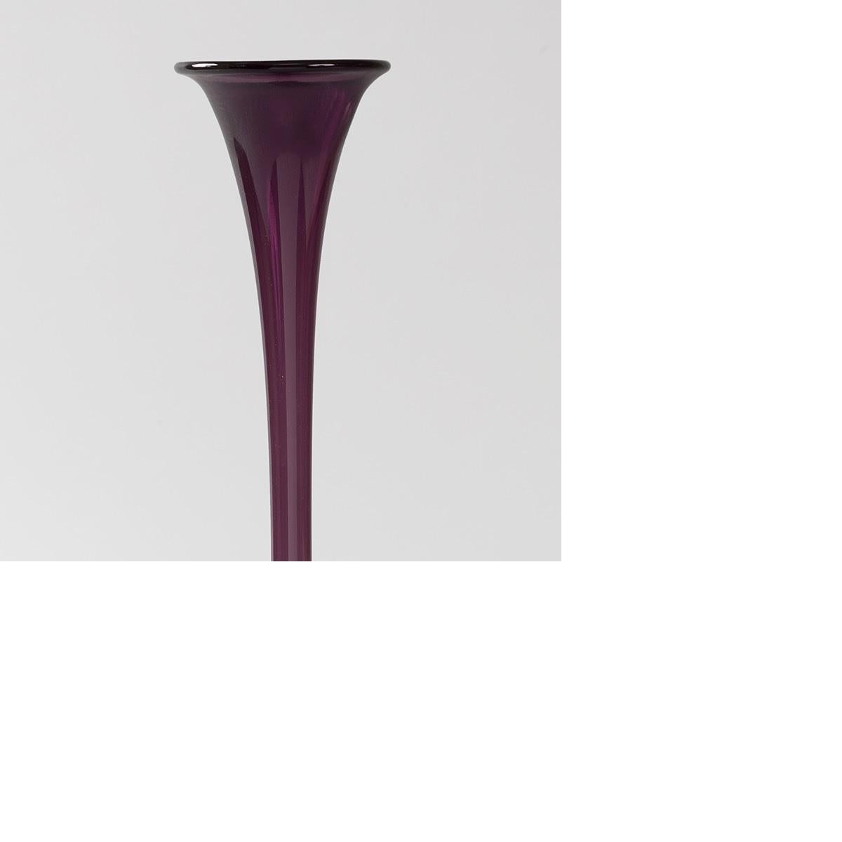 An Austrian slender and tall vase in deep purple glass by Karl Koepping.  The vase's color is reminiscent of the purple traditionally made from the spiny dye-myrex snail at great expense and associated with royalty., circa 1899. 

A similar vase is