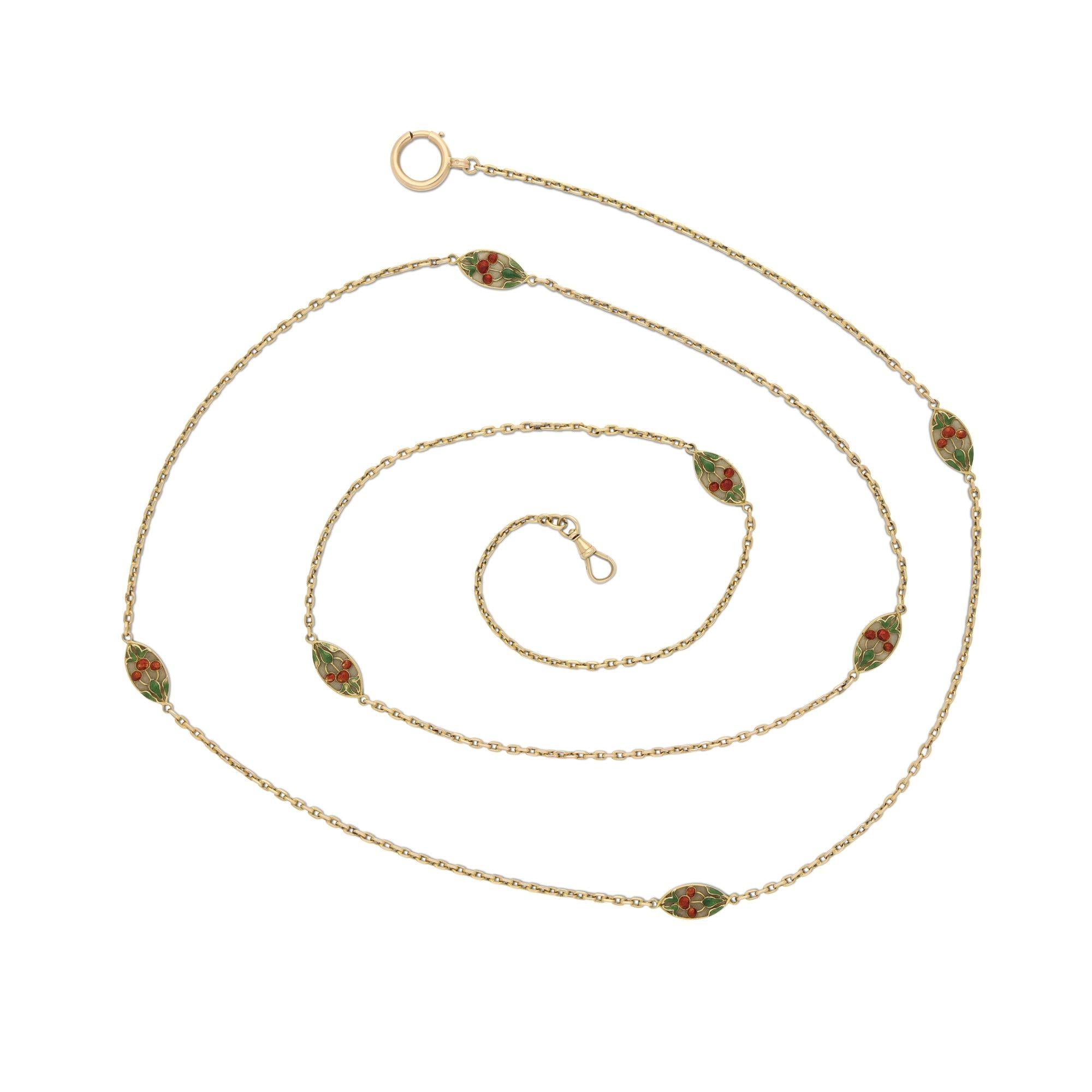 An antique gold and enamel long chain necklace c.1910, the necklace measuring 45” in length and formed of a continuous box-link chain interspersed at regular intervals with seven navette shaped panels decorated in red and green enamel with three