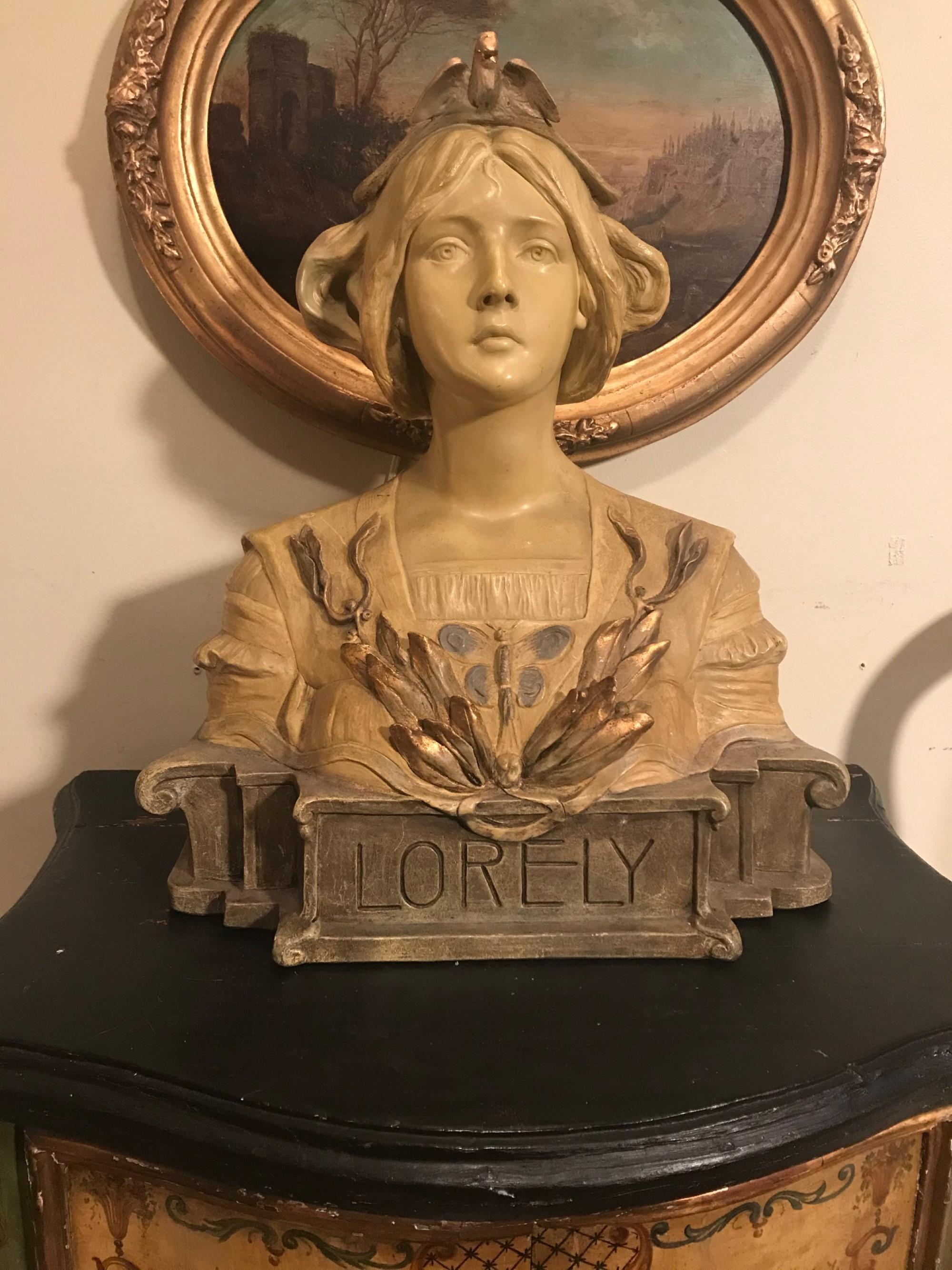 Antique Austrian Goldscheider terracotta bust of Lorely, circa 1900

This is a superb and large Art Nouveau polychrome painted terracotta bust of the German river maiden, ‘Lorely” (Lorelei). This rare bust was created and modeled by the sculptor,