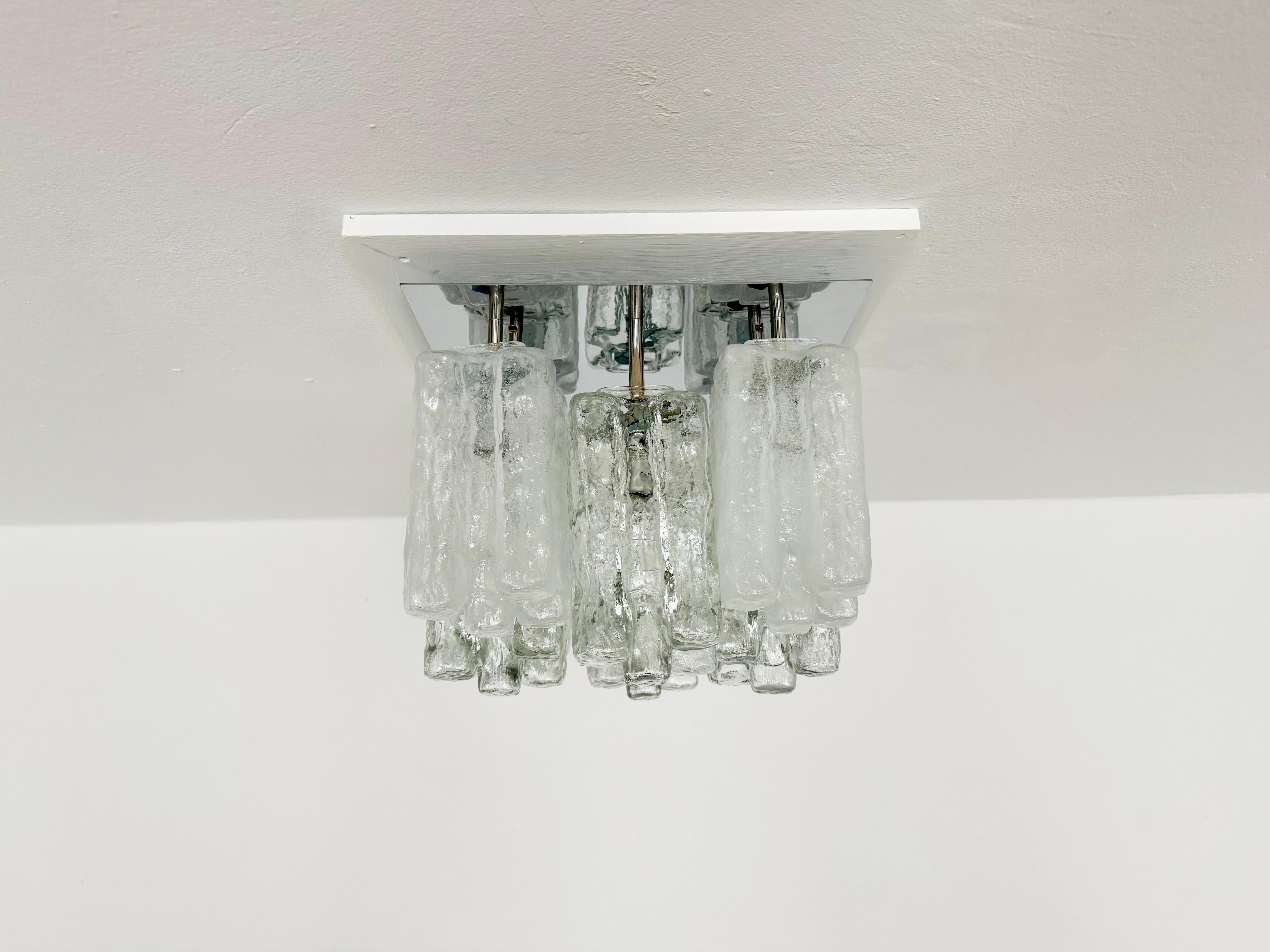 Wonderful ice glass ceiling lamp from the 1960s.
The beautifully shaped Murano glass elements create an impressively sparkling play of light.
Very high-quality workmanship and a real eye-catcher for any home.
Exceptionally rare with this glass
