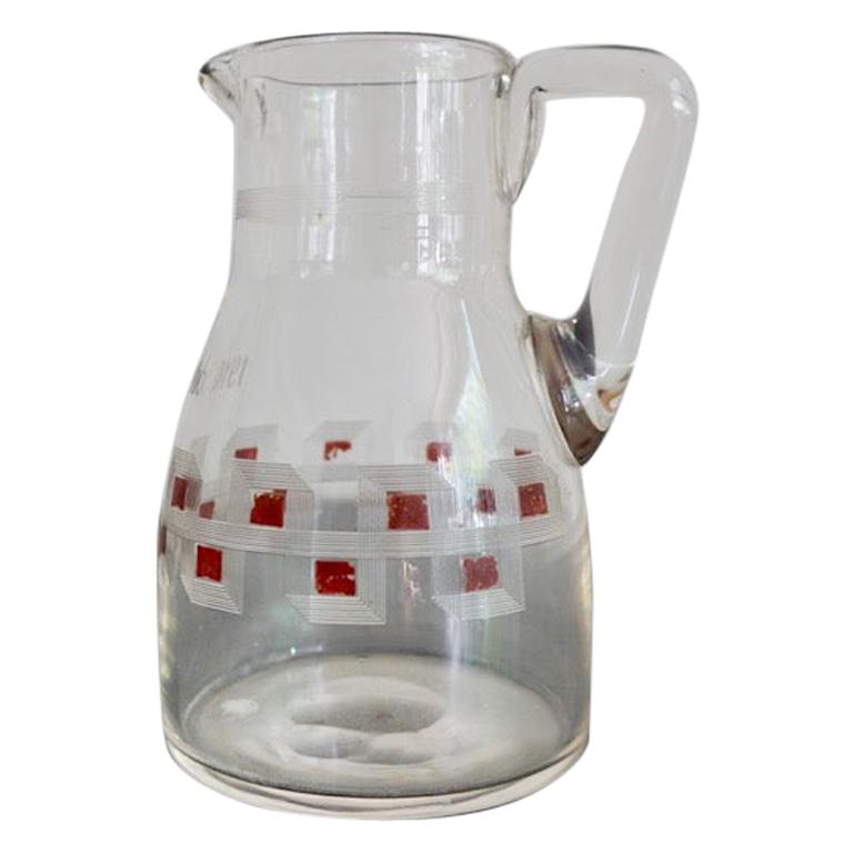 Austrian Jugendstil glass milk jar
This elegant glass milk jug is a perfect example of Austrian Jugendstil. The milk jug made of pressed glass engraved by hand. Ruby colored squares are creating ornament typical for the period. The numbers 1910.V.