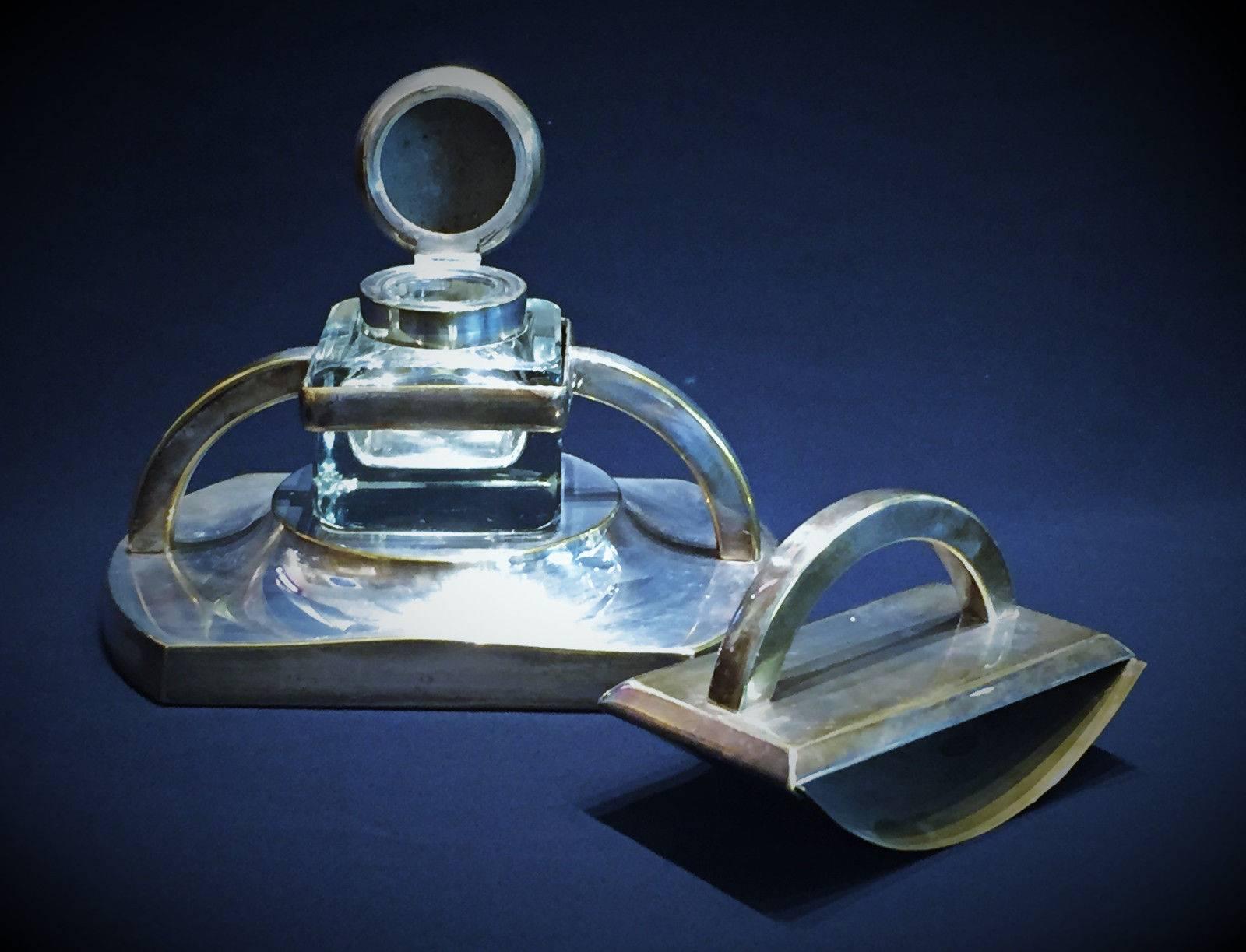 Wonderful in its unique Austrian Jugenstil style and very strong masculine streamlined design, this stunning desk set of inkstand and ink rocker blotter was made in Vienna, Austria, circa 1900. Unmarked. 

Dimensions:
Inkstand base: H: 6 x W: 9 x