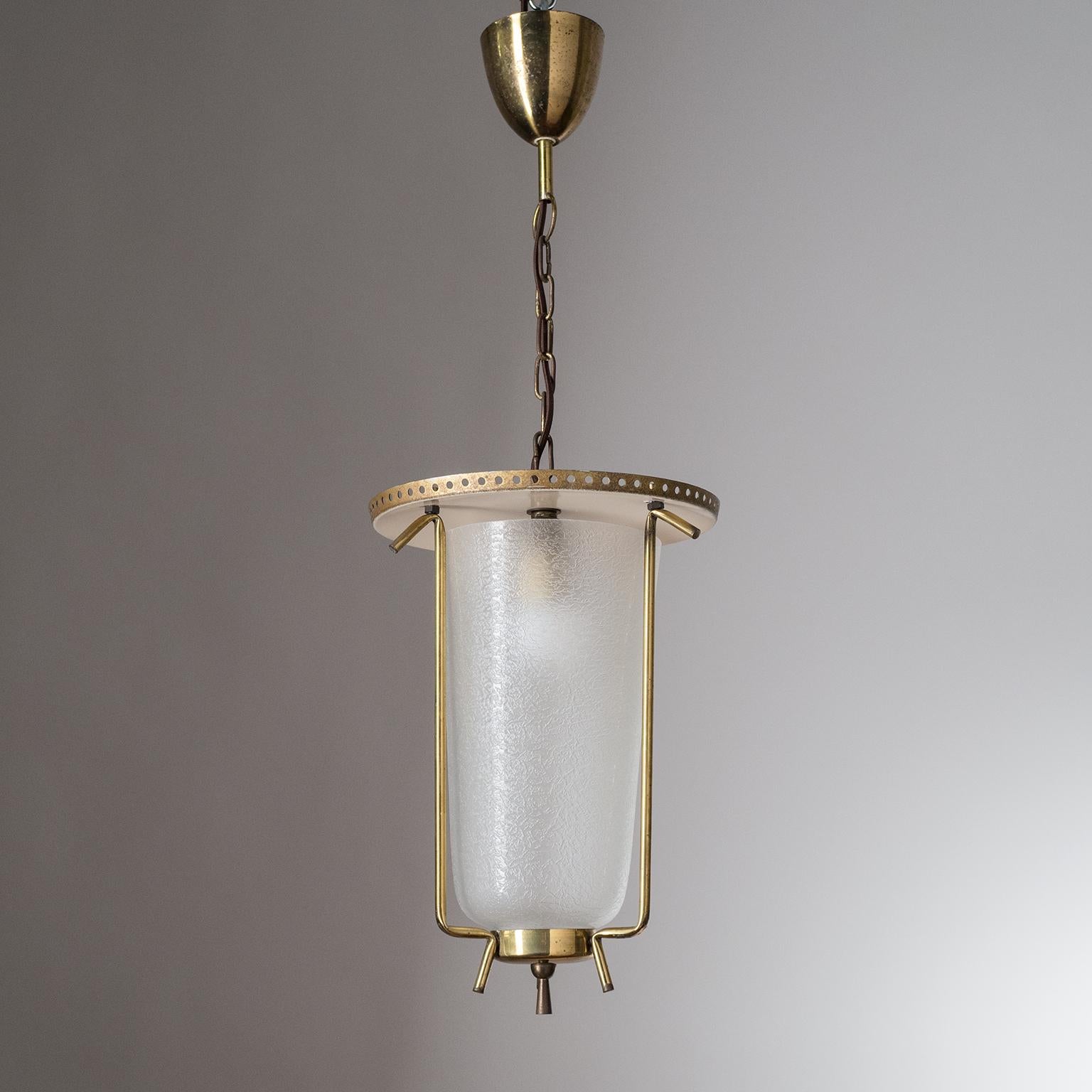 Charming mid-century brass and glass lantern from Austria, circa 1950. A perforated lacquered aluminum shade sits atop a textured glass diffuser. Very nice original condition with some patina on the brass and light wear to the top of the lacquered