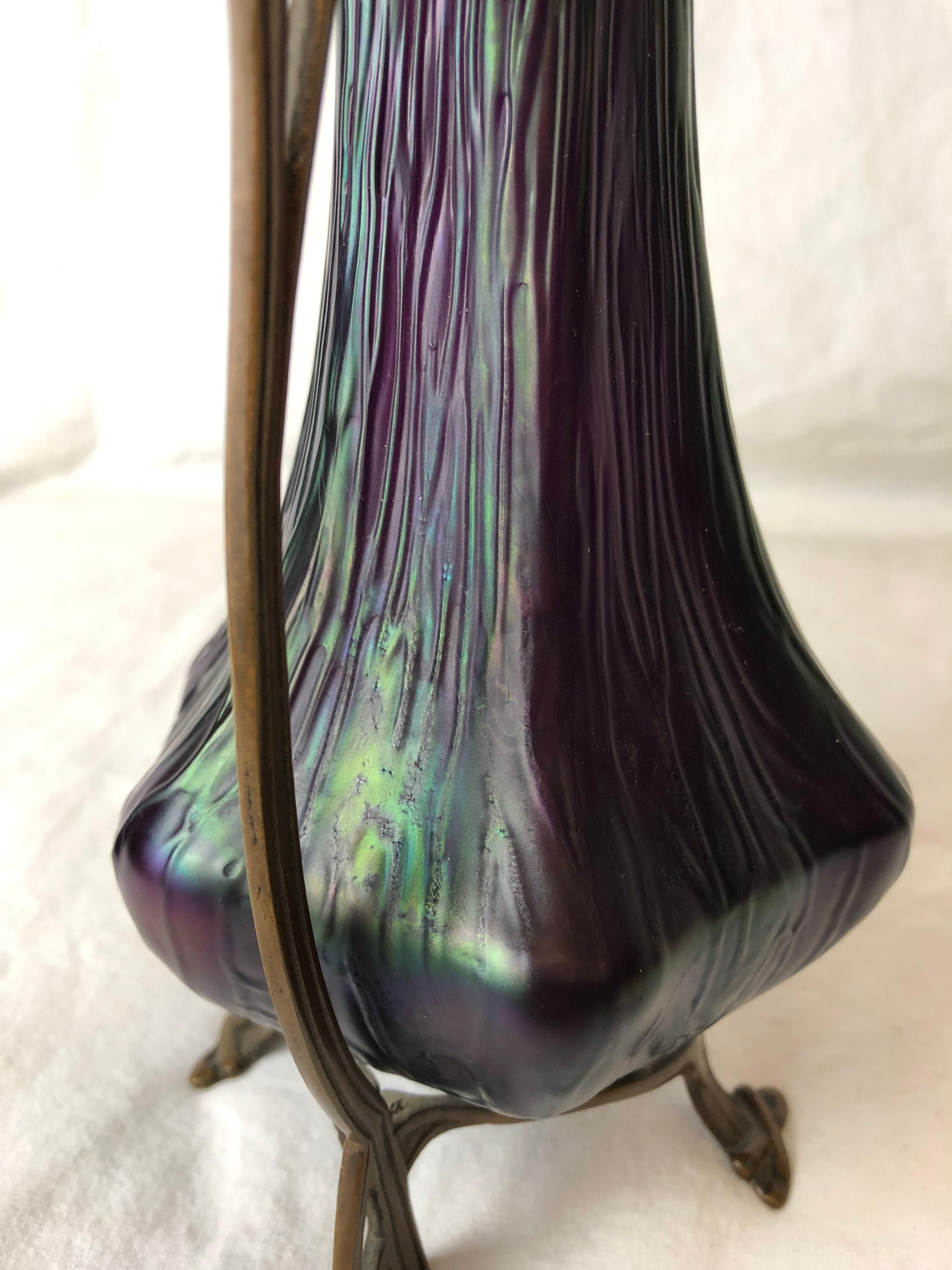 Austrian Loetz Art Nouveau rippled purple and iridescent glass vase with bronze floral stand. 


 
