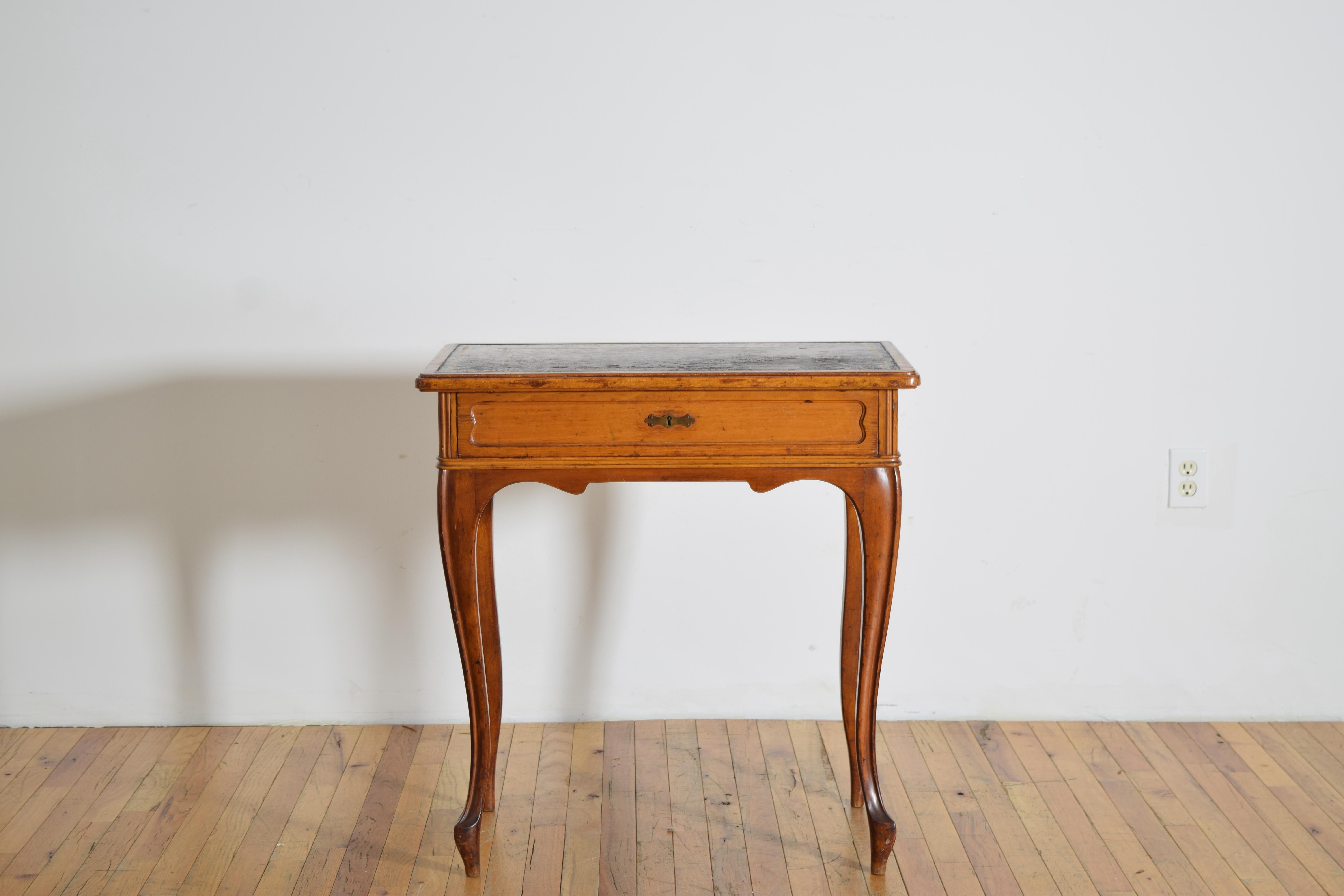 A finely proportioned Louis XV style writing or side table in light walnut, raised on slender cabriole legs terminating in hoof feet.  The single drawer retains its original brass lock stamped “Bernh. Ludwig Wien” with inventory number, confirming