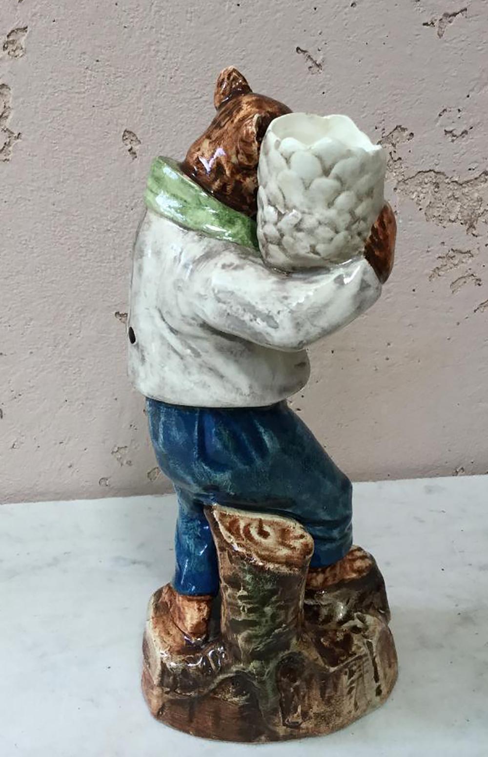 Austrian Majolica candelstick with a dressed bear holding a cone pine circa 1890.