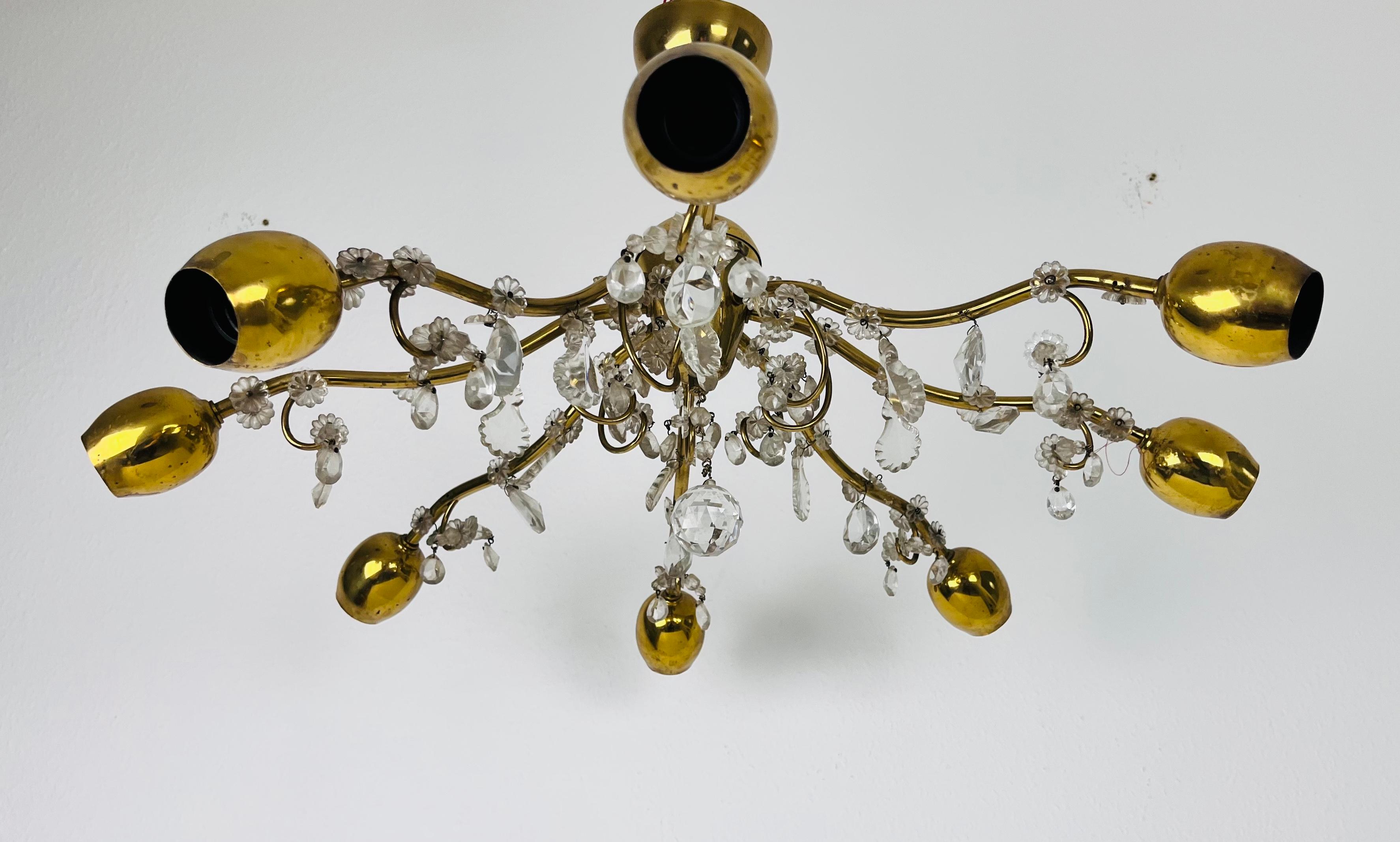 A Sputnik chandelier made by Lobmeyr in the 1960s. It is fascinating with its brass and crystal arms, each of it with an E14 light bulb. The shape of the light is similar to a spider.

The light requires 8 E14 light bulbs. Works with both