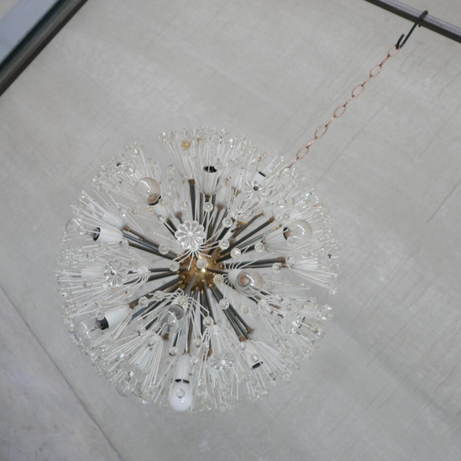 An early model pendant light by Emil Stejnar for Rupert Nikoll. 

Austria, c1950s. 

Brass centre with glass decorations. 

Hung on a chain. 

Re-wired and PAT tested.

Location: Belgium Gallery. 

Dimensions: 55 Diameter in cm.