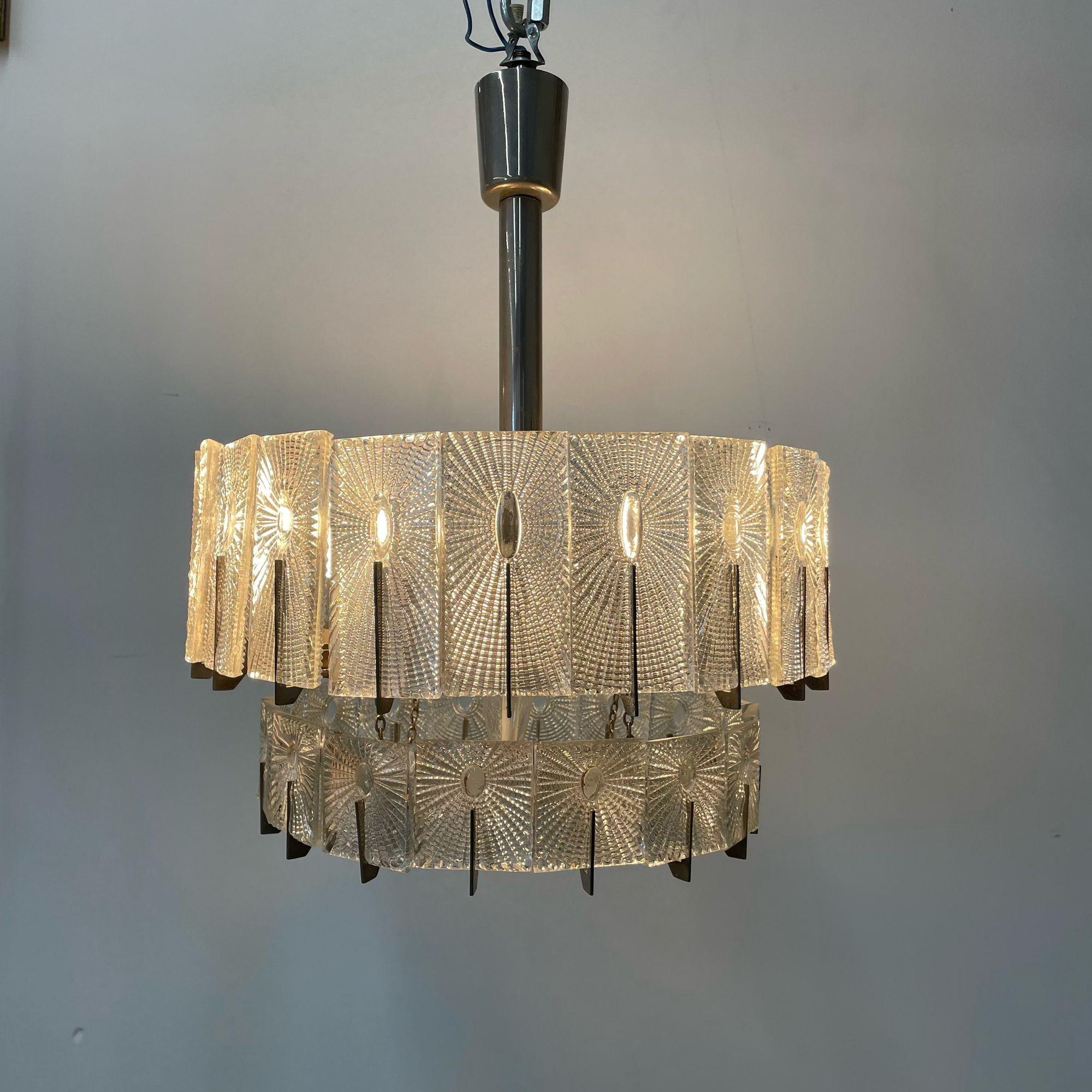 Austrian Mid-Century Modern Two-Tier Chandelier / Pendant, Glass, Rupert Nikoll
 
Modern tiered chandelier designed and produced in Vienna, Austria circa 1950s. Having a dual tier chrome base with handing decorative rectangular art glass pieces.
