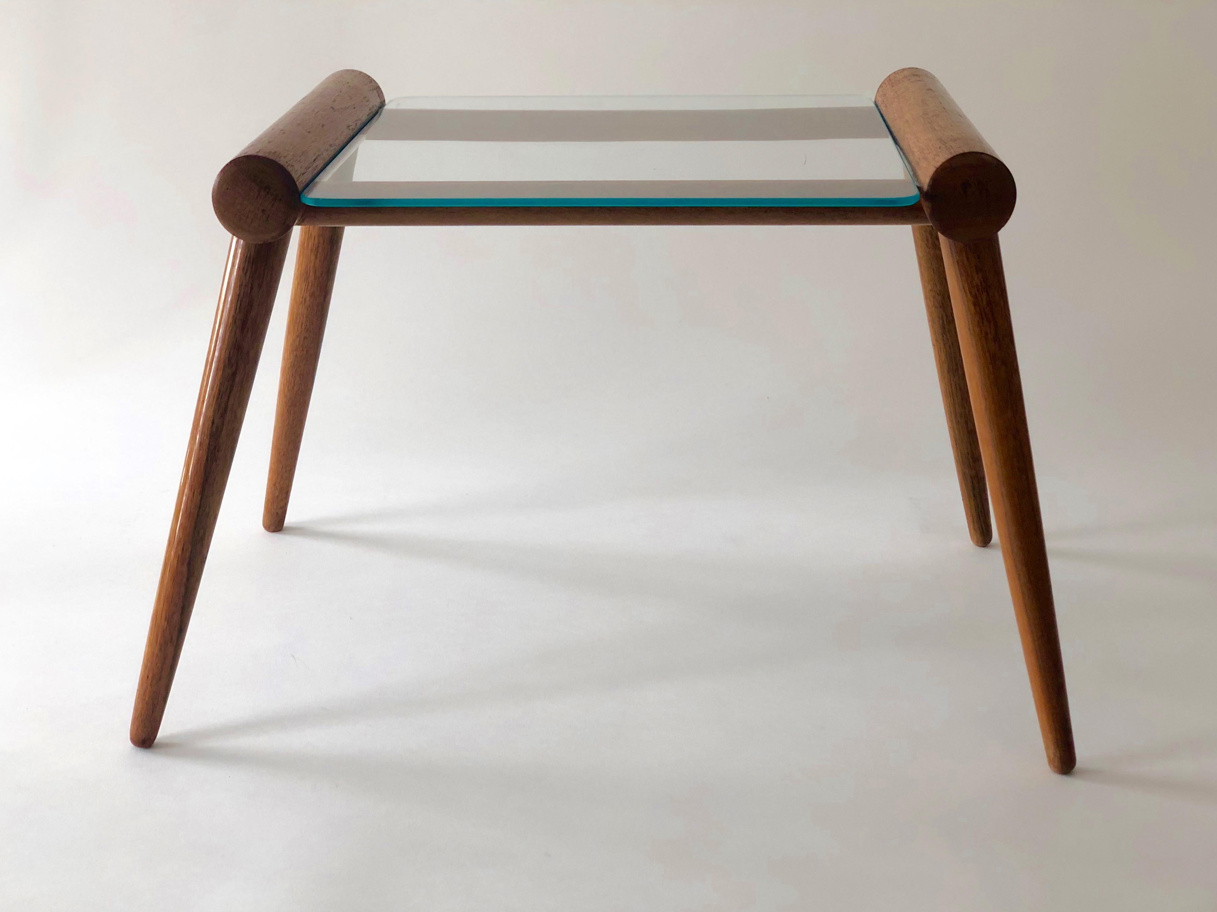 A simple, elegant table, designed by Max Kment, in the 1950s, and produced by Kunstgewerbliche Werkstätten in Austria.
The table is composed of wooden base made out of maple wood and a glass plate for the top.
Both elements have been kept in