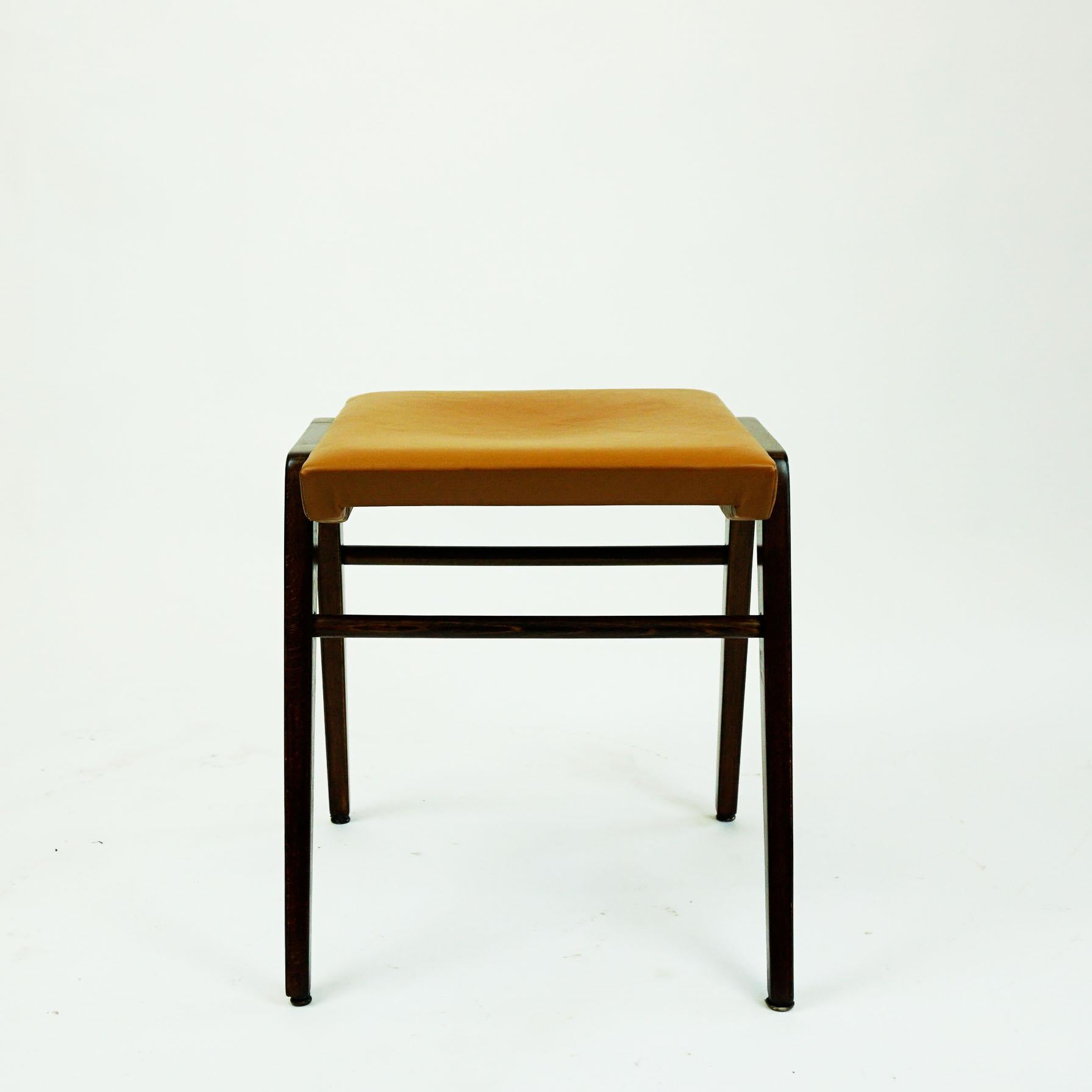 Authentic Austrian midcentury vintage beechwood and leather stool designed by Franz Schuster 1952 and produced by Wiesner Hager.. It has a beechwood frame and the seat is covered with renewed cognac brown Leather. which is in excellent restored