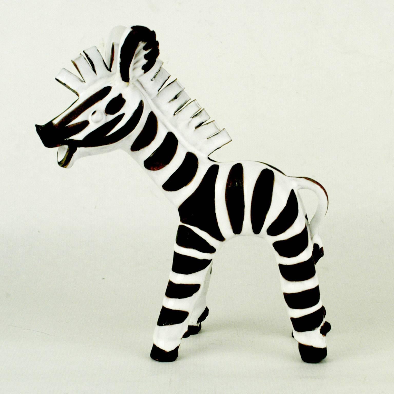 This charming humoristic Zebra sculpture has been designed and manufactured by the Viennese Midcentury artist Leopold Anzengruber. Born in 1912 he founded his own company Anzengruber Keramik Wien in 1949 where he created his rich oeuvre, very well