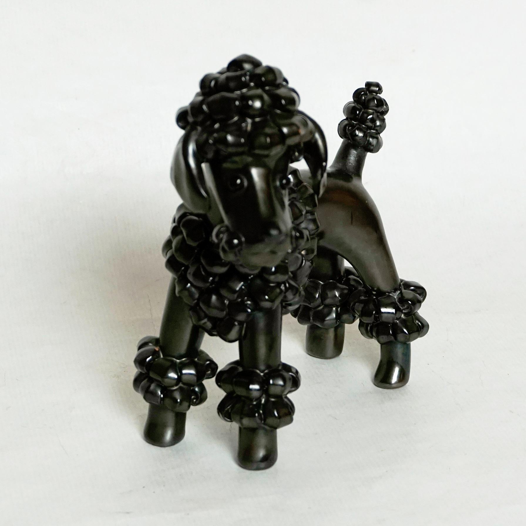 Amazing black shining glazed dog ceramic sculpture designed and executed by the Austrian Artist Leopold Anzengruber, Mod. No 184 in the 1950s. Excellent condition, original manufacturer´s label on the underside.
This poodle is mentioned in the