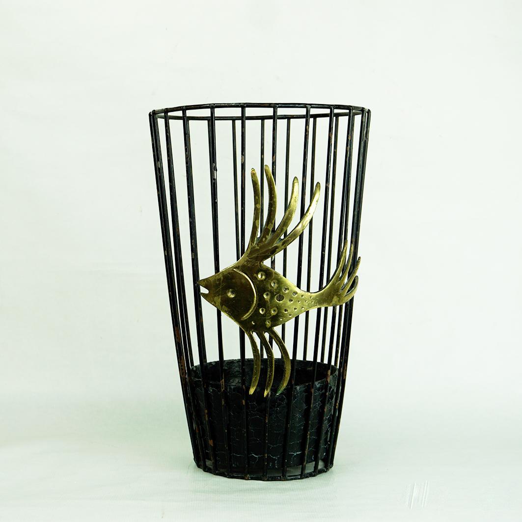 This Mid-Century Modern vintage umbrella stand or paper basket from metal and brass has been designed by Walter Bosse 1950s Austria and produced by Herta Baller.
The stunning fish like brass detail performs the umbrella stand for a charming basket