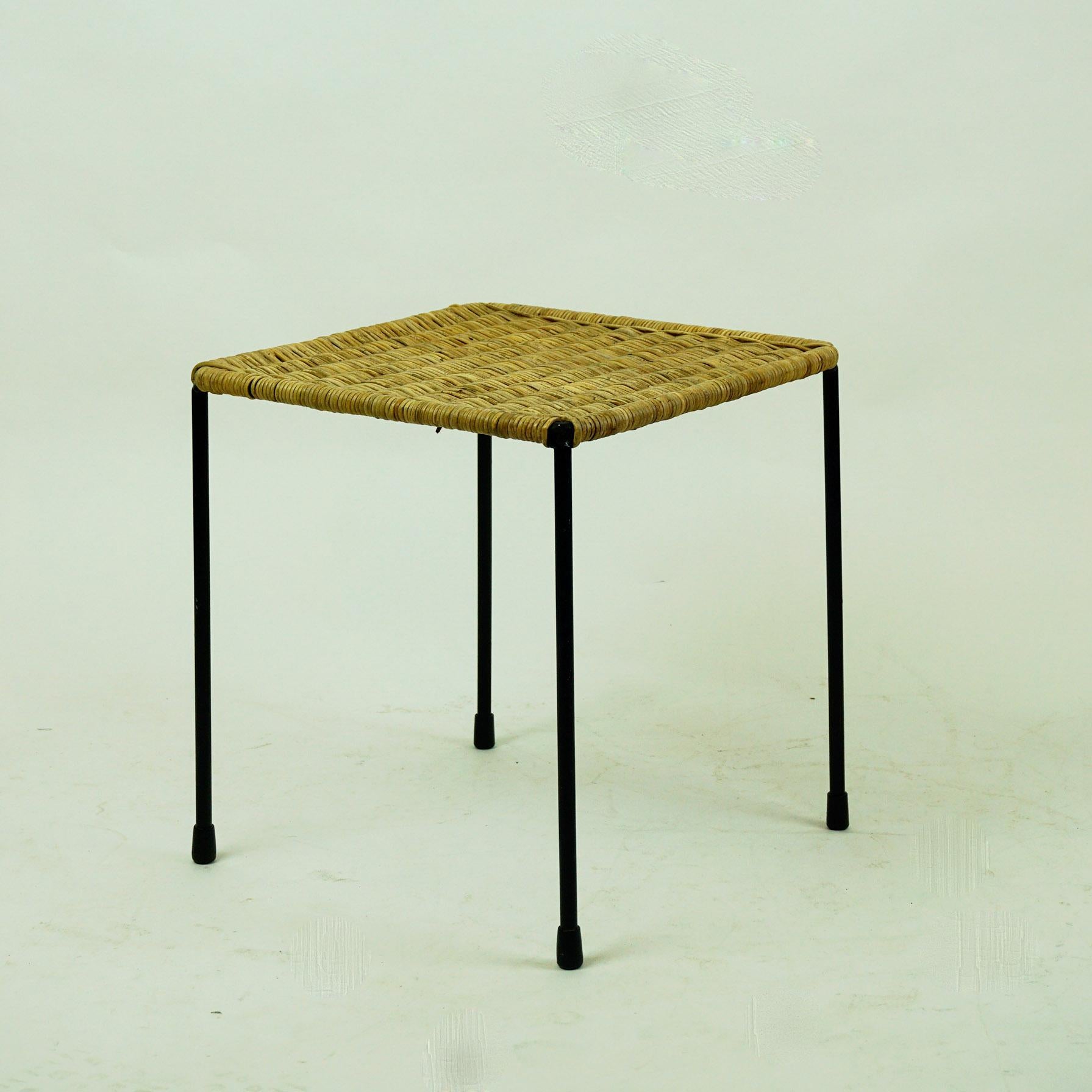 A charming small square sized table or stool designed and made by Carl Auböck II, Vienna, Austria, circa 1950 in beautiful original condition.
It´s frame is made from slender steel which has been lacquered in black and it has rubber shoes at the