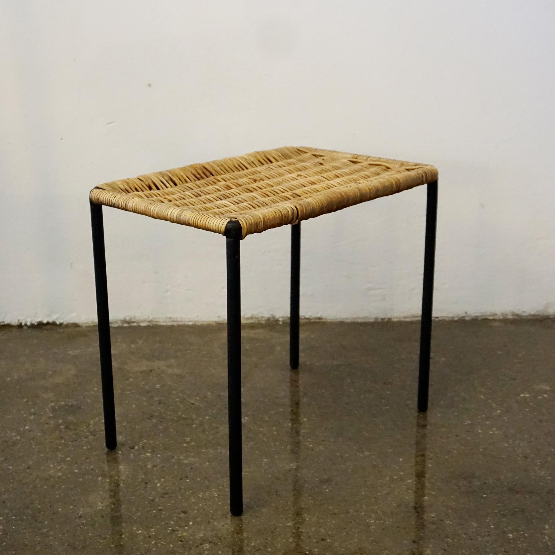 A charming small square sized table or stool designed and made by Carl Auböck II, Vienna, Austria, circa 1950 in beautiful original condition.
It´s frame is made from slender steel which has been lacquered in black and it has rubber shoes at the