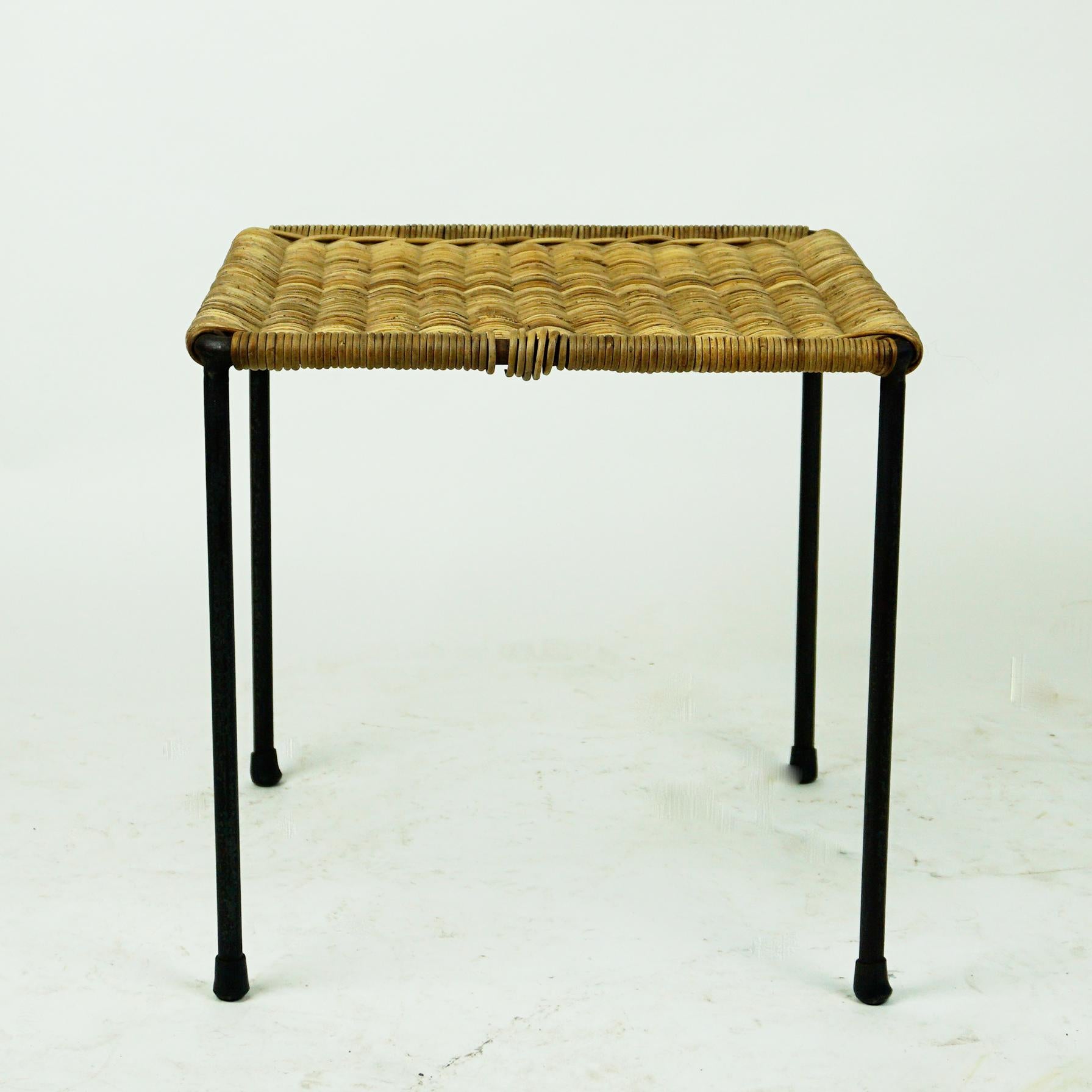 A charming small square sized table or stool designed and made by Carl Auböck II, Vienna, Austria, circa 1950 in beautiful original condition.
It´s frame is made from slender steel which has been lacquered in black and it has rubber shoes at the