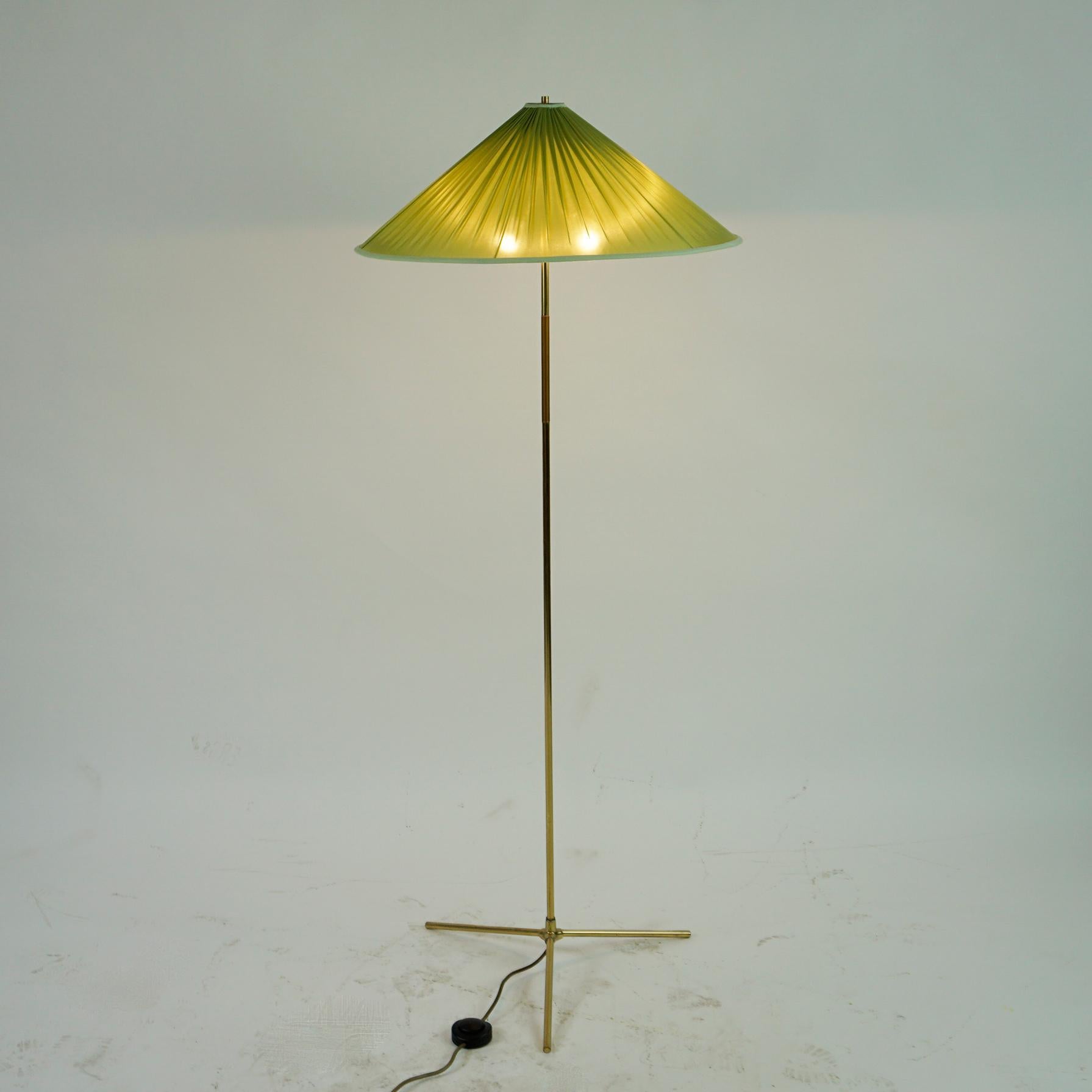 This charming Mid-Century Modern brass floor lamp has been designed and executed in Vienna Austria, 
It feaatures a tripod brass base and brass stem with two E27 light sockets.
Its style and quality of manufactury is very close to lights produced