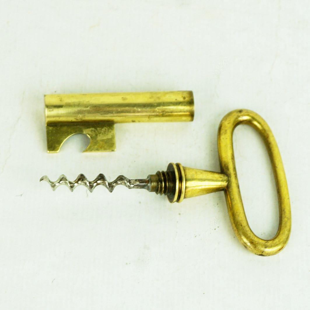 
A sculptural Midcentury corkscrew and bottle opener combination from the 1950s. In the shape of a large key, designed by Carl Aubock, executed by Carl Aubock workshop in Vienna, Austria. This is a vintage original, made of solid brass. A Carl