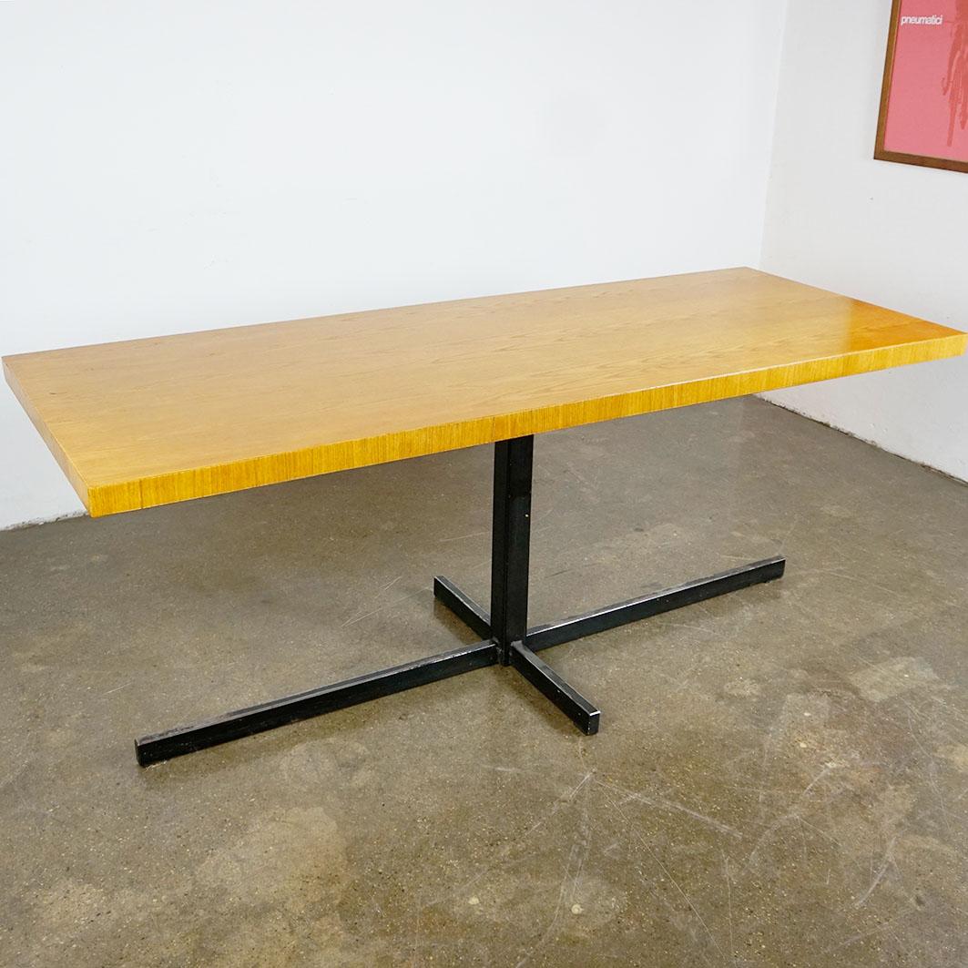 This fantastic Austrian midcentury dining table has been designed in Vienna 1950s. It features a central blackened steel construction with a bright pine veneered top which has been slightly restored.
 It has an outstandig pure design which is very