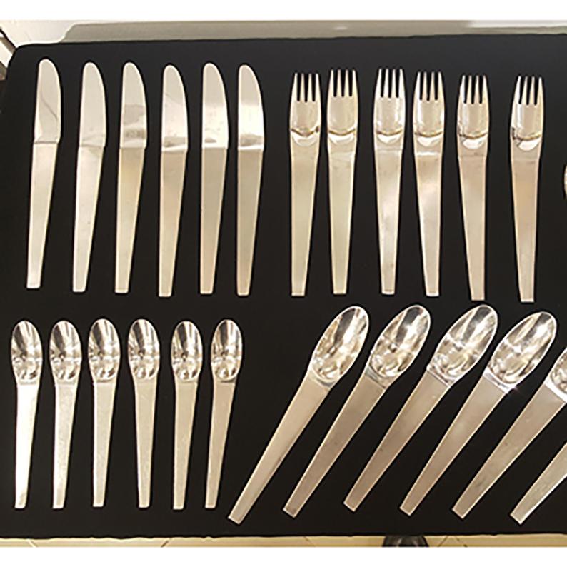 This Set of Austrian flatware from the 1950s, was designed by Carl Auboeck 1955 and executed by Amboss Neuzeug Austria. This is the famous flatware set model no. 2060, a mid century classics, made of polished and brushed stainless steel. 
The Set