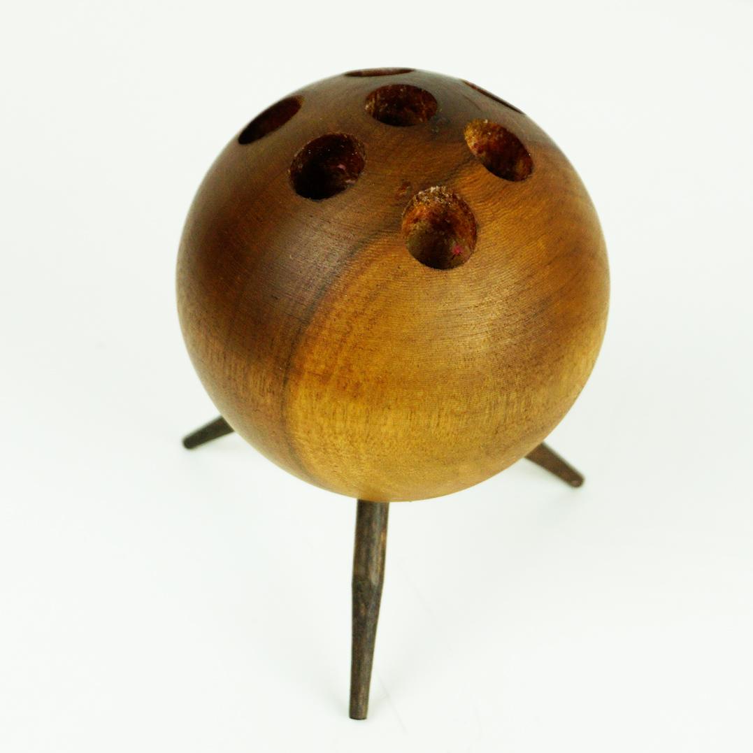 This charming Austrian Midcentury Modern candleholder was designed and crafted by Carl Auböck for Werkstätte Carl Auböck in Vienna Austria, Mod. No 4661.
It features a ball-shaped design with a tripod base and is crafted from solid walnut wood.  It
