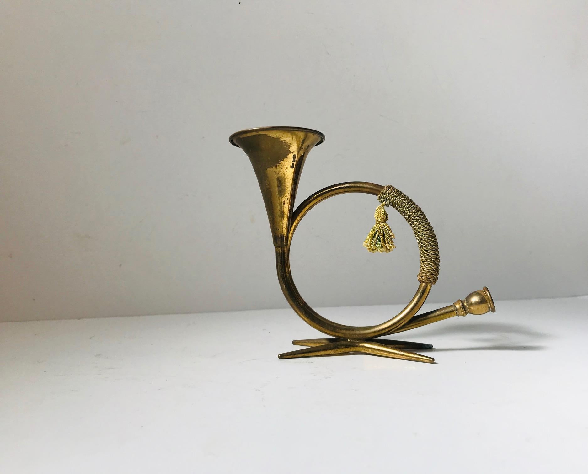 Curious and decorative candleholder shaped as a hunting horn. Designed and manufactured in Austria in a style reminiscent of Carl Auböck and Hagenauer. Candle size: regular.