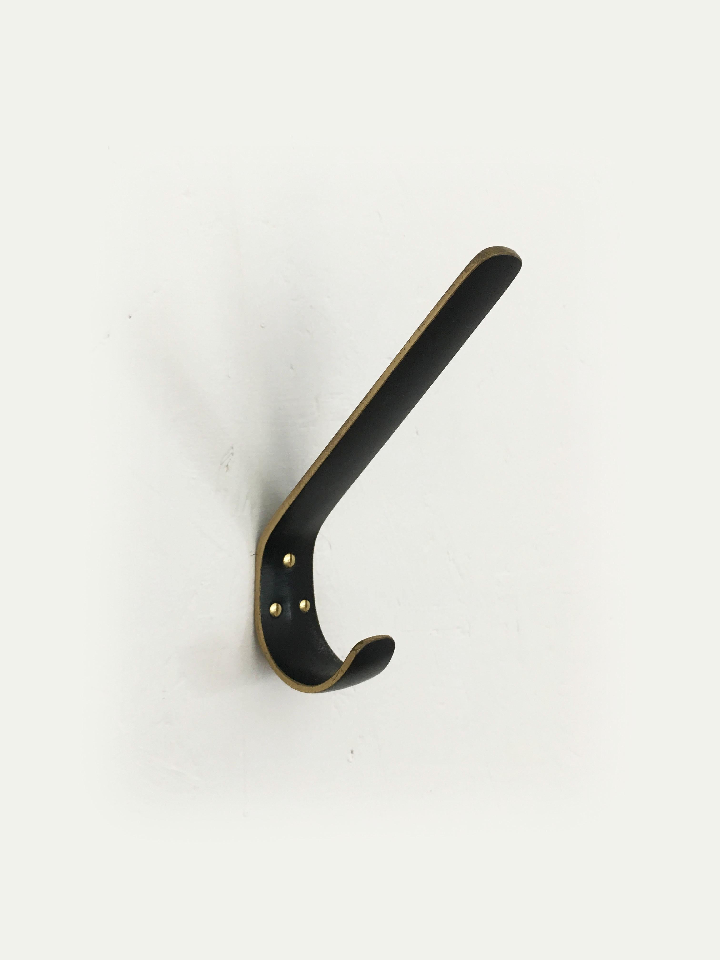 A set of very rare nine beautiful Austrian brass wall hooks, made of black-finished brass, partly polished, executed in the 1950s by Hertha Baller, Austria. A large and impressive design, in excellent condition, very minimal gentle wear.. with