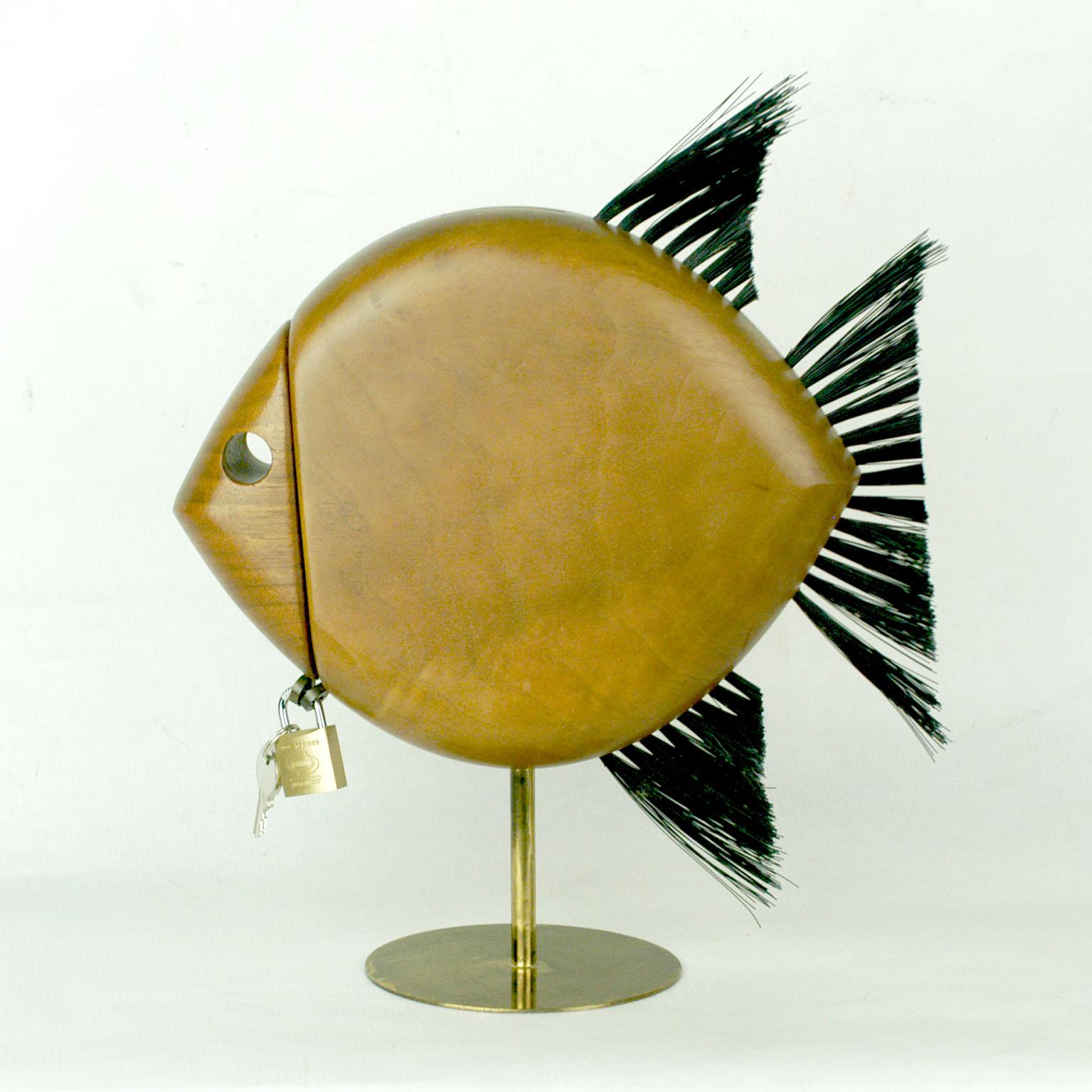 Charming wooden fish shaped money box with brass details by saught after Austrian architect and designer Carl Auböck.
It can be used for your savings or as well be admired as excellent manufactured animal sculpture. Lock later addition.
Signed on