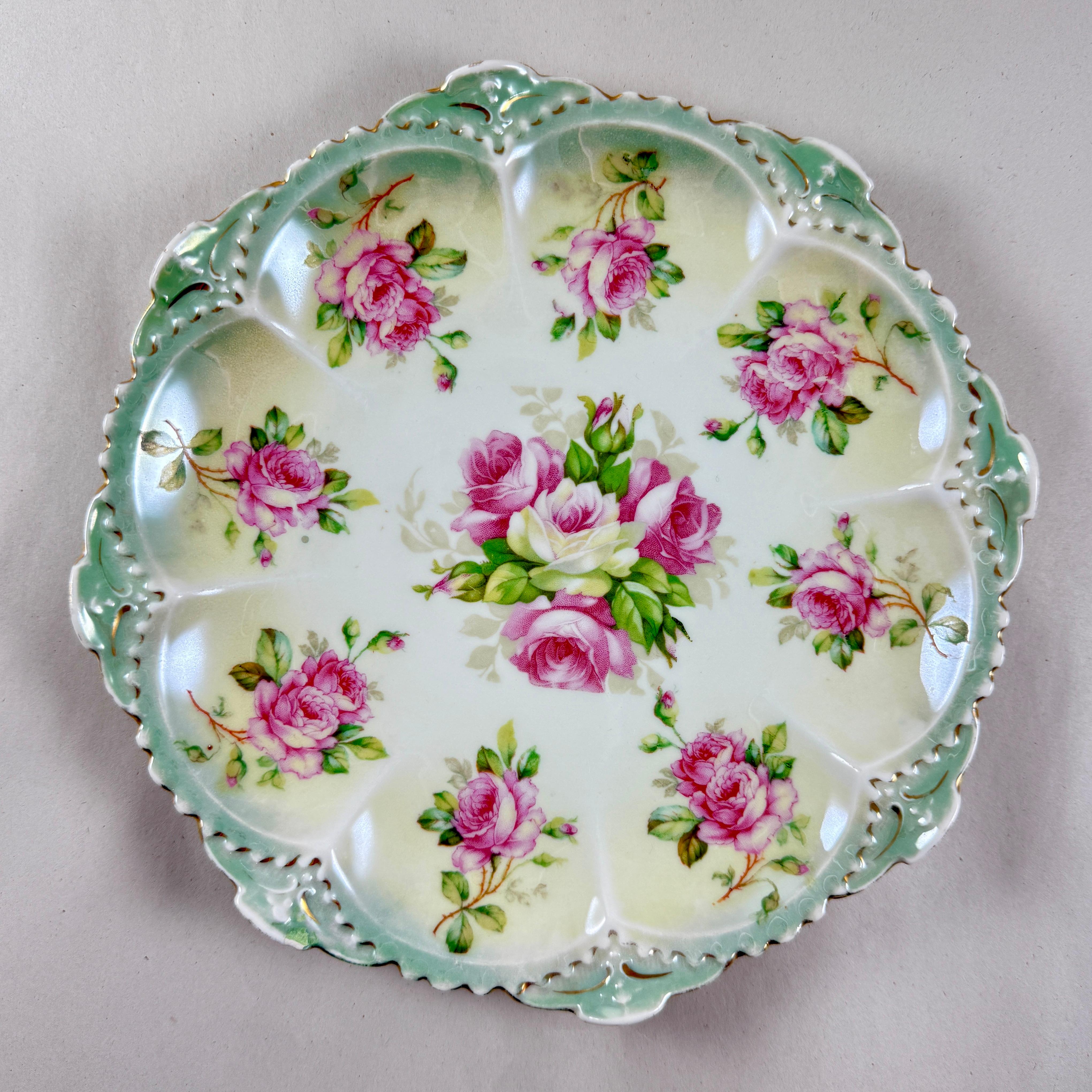 A porcelain plate with pink roses and a gilded beaded border, by M&Z Austria, circa 1900.

“M&Z Austria” porcelain was produced by Moritz Zdekauer in Altrohlau, Austria, now part of the Czech Republic, from 1884-1909.

They are known for their