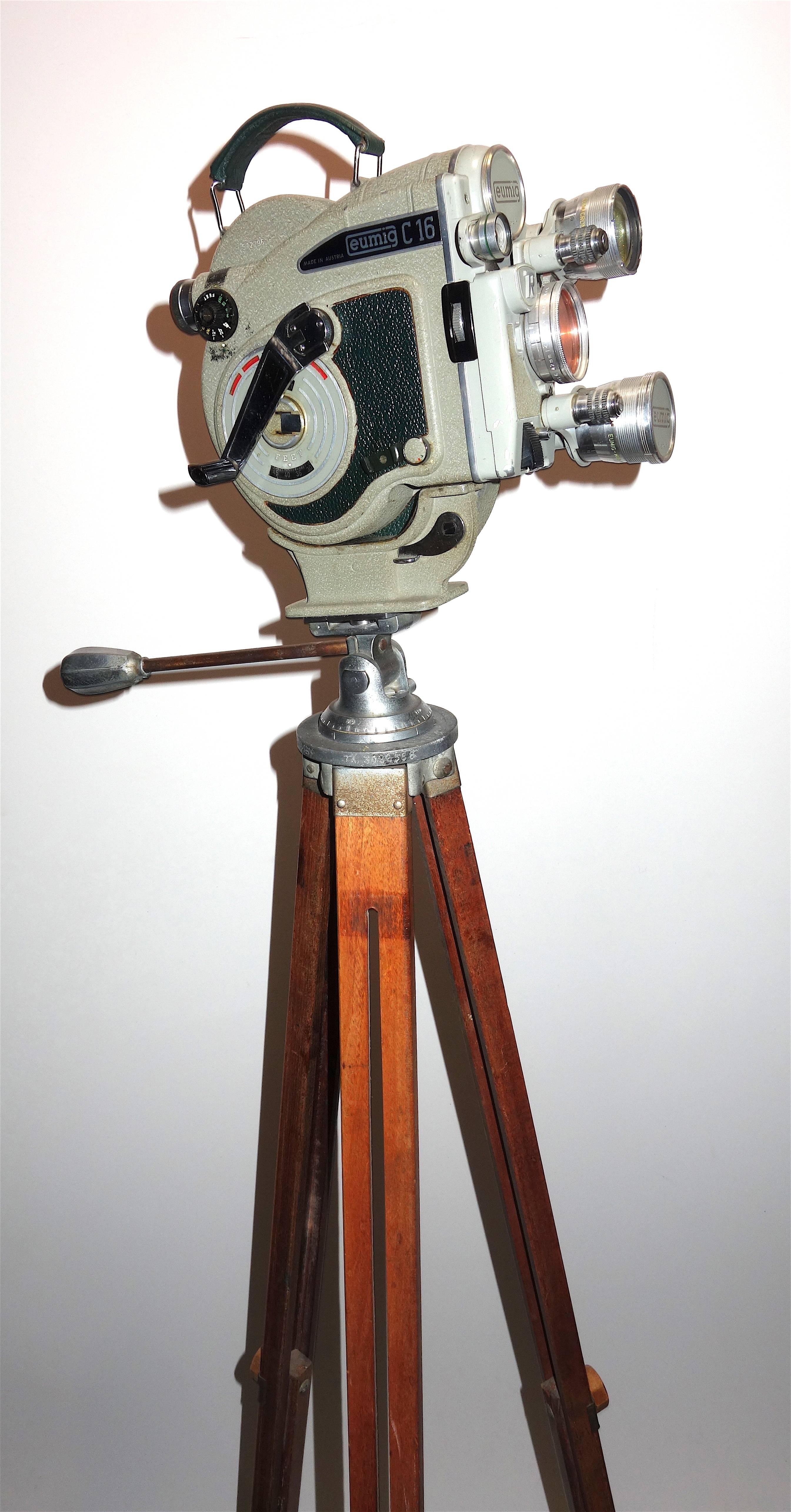 Submitted for your consideration is this rare Austrian made Eumig Cinema camera, circa 1956. Eumig was founded in the very early 20th century.
The supplied wooden tripod is a beautiful midcentury example. This model was Eumig's first attempt at a