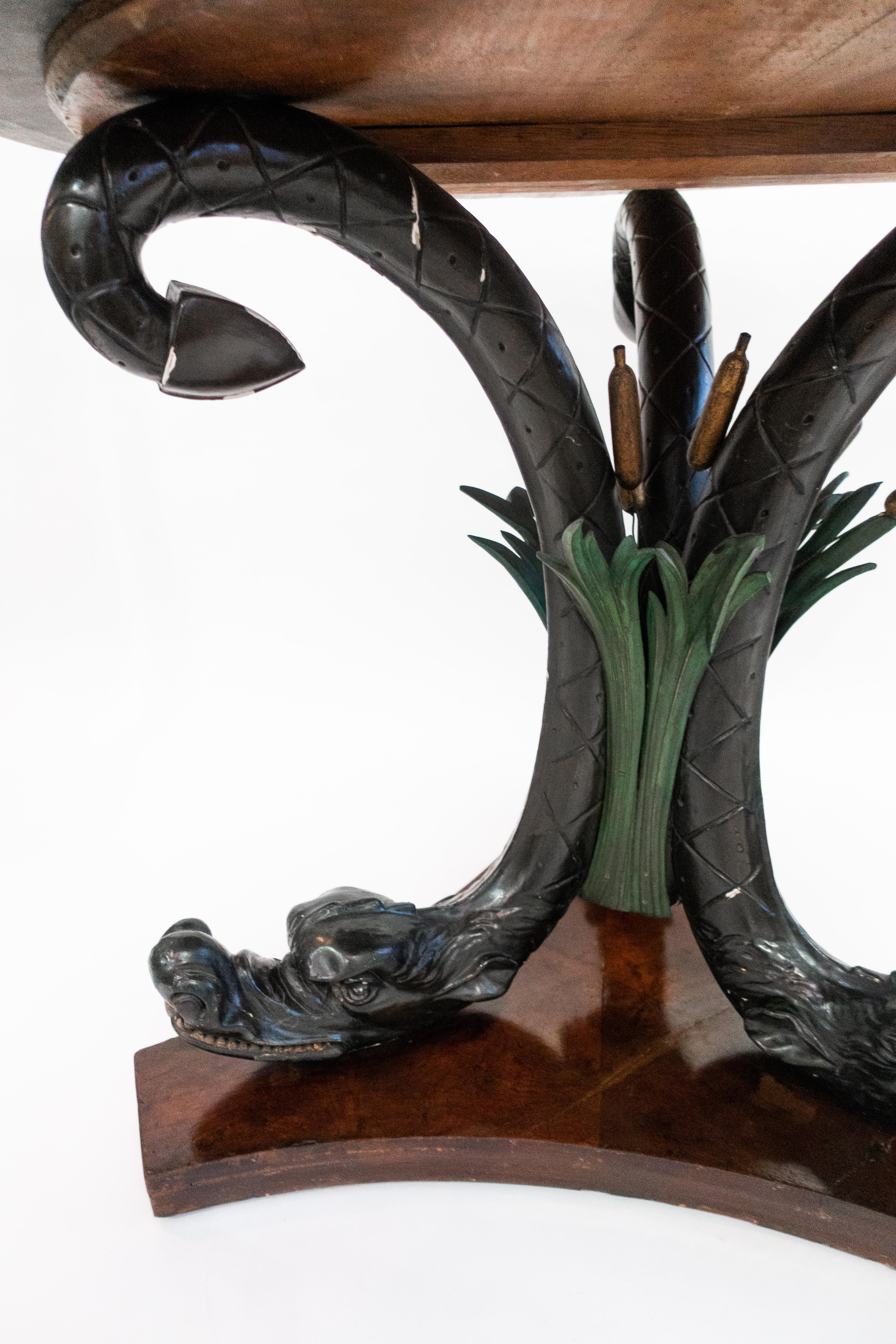 Austrian neoclassical mahogany, ebonized and parcel-gilt center table. Round with dragon and reed decoration. The top is grey fossilized marble.