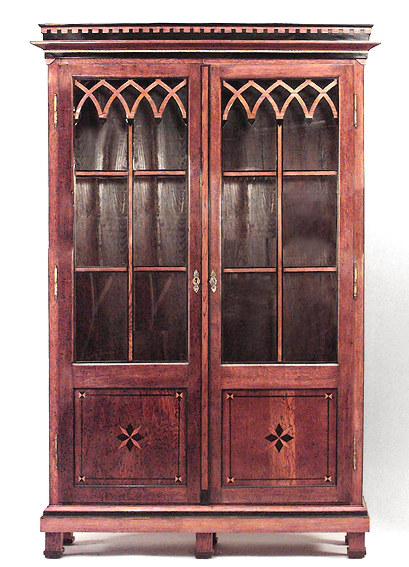 Continental Austrian neoclassical style oak bookcase cabinet with geometric inlay, gilt egg-and-dart detail, ebonized trim, and Gothic filigree on front doors, circa 1790.
  