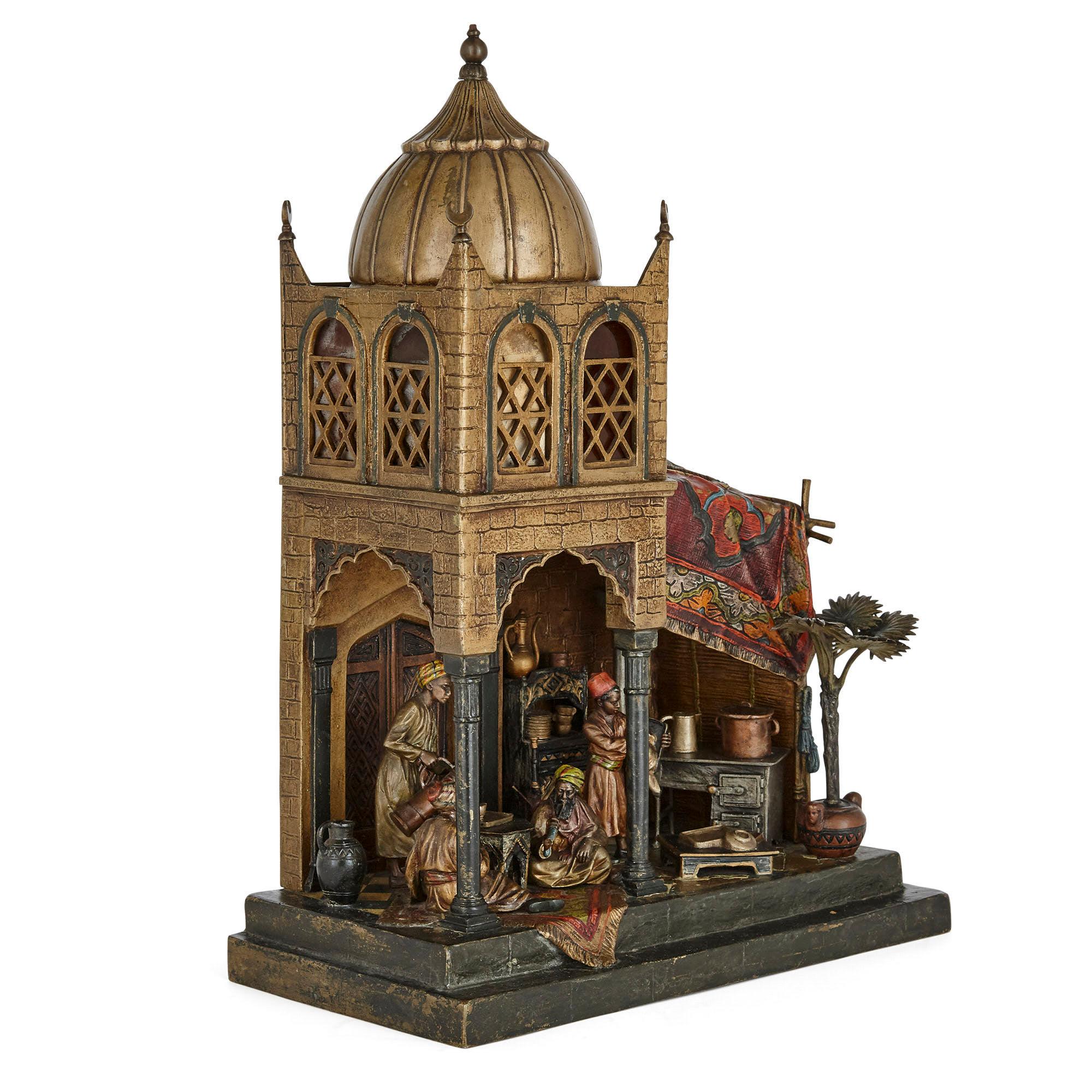 Austrian Orientalist bronze model lamp by Anton Chotka.

This charming cold-painted bronze lamp depicts a busy scene of an open plan coffee shop within an Islamic style building, which features a dome ceiling, crescent moon finials and Moorish