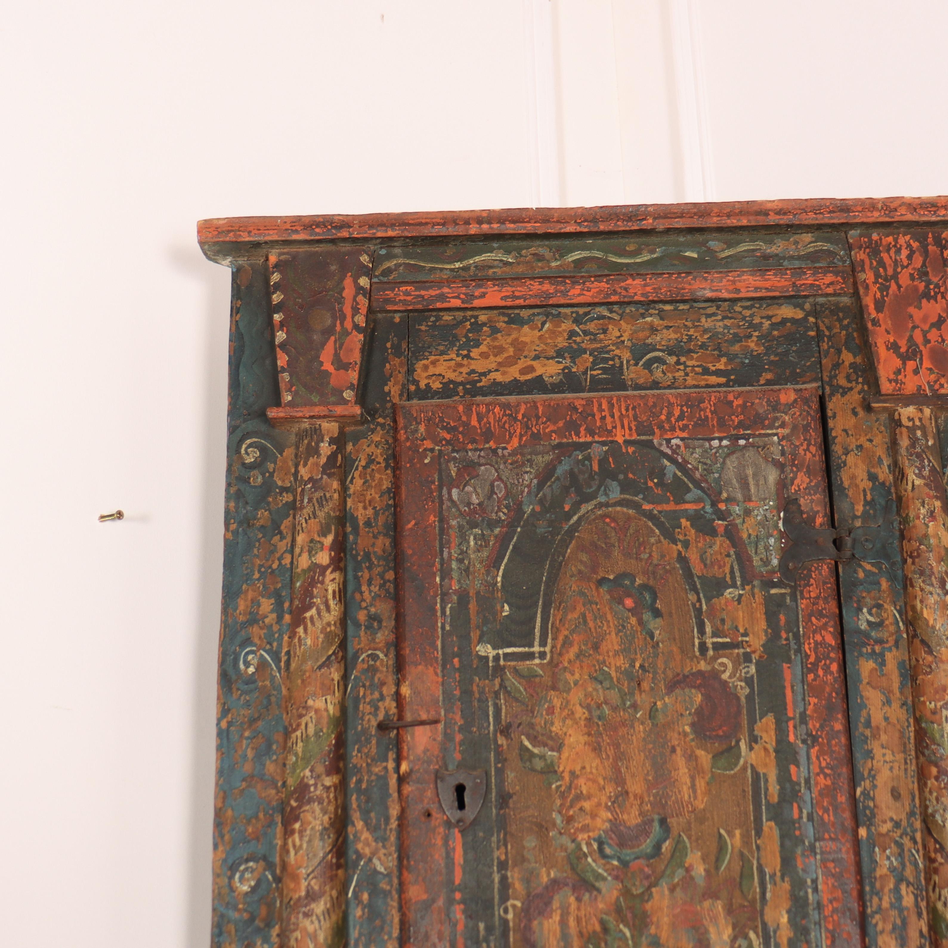 Pretty early 19th century Austrian hanging corner cupboard. Decorated with an original painted folk art design. 1820.

This will fit into an 18