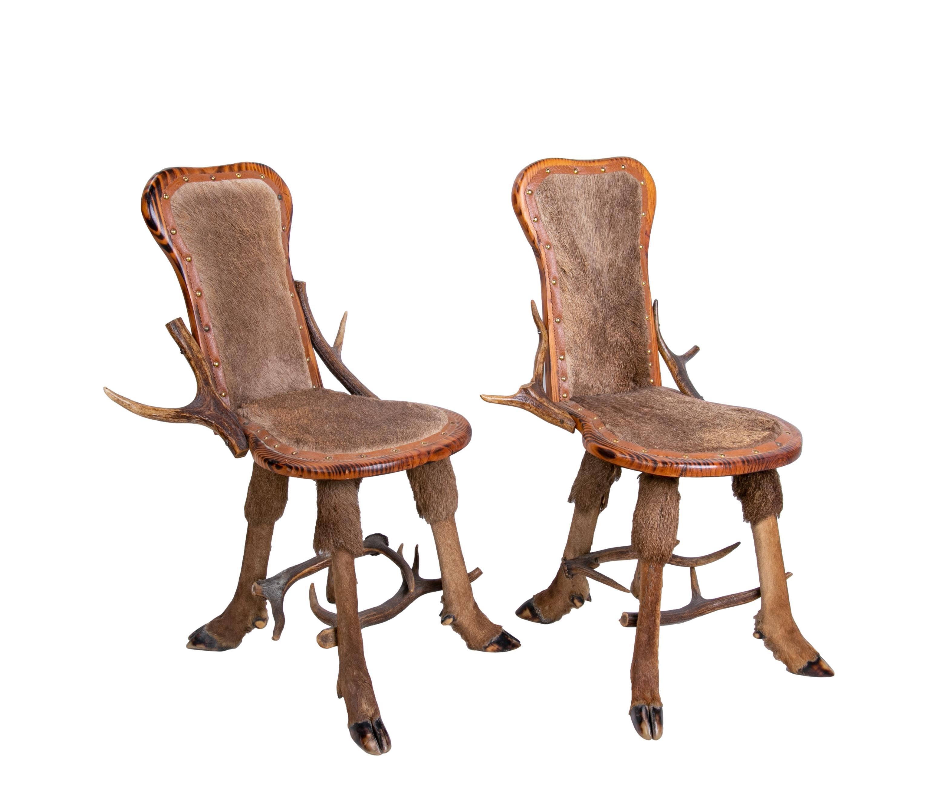 Austrian pair of armchairs made of antlers, animal backrest and seat.