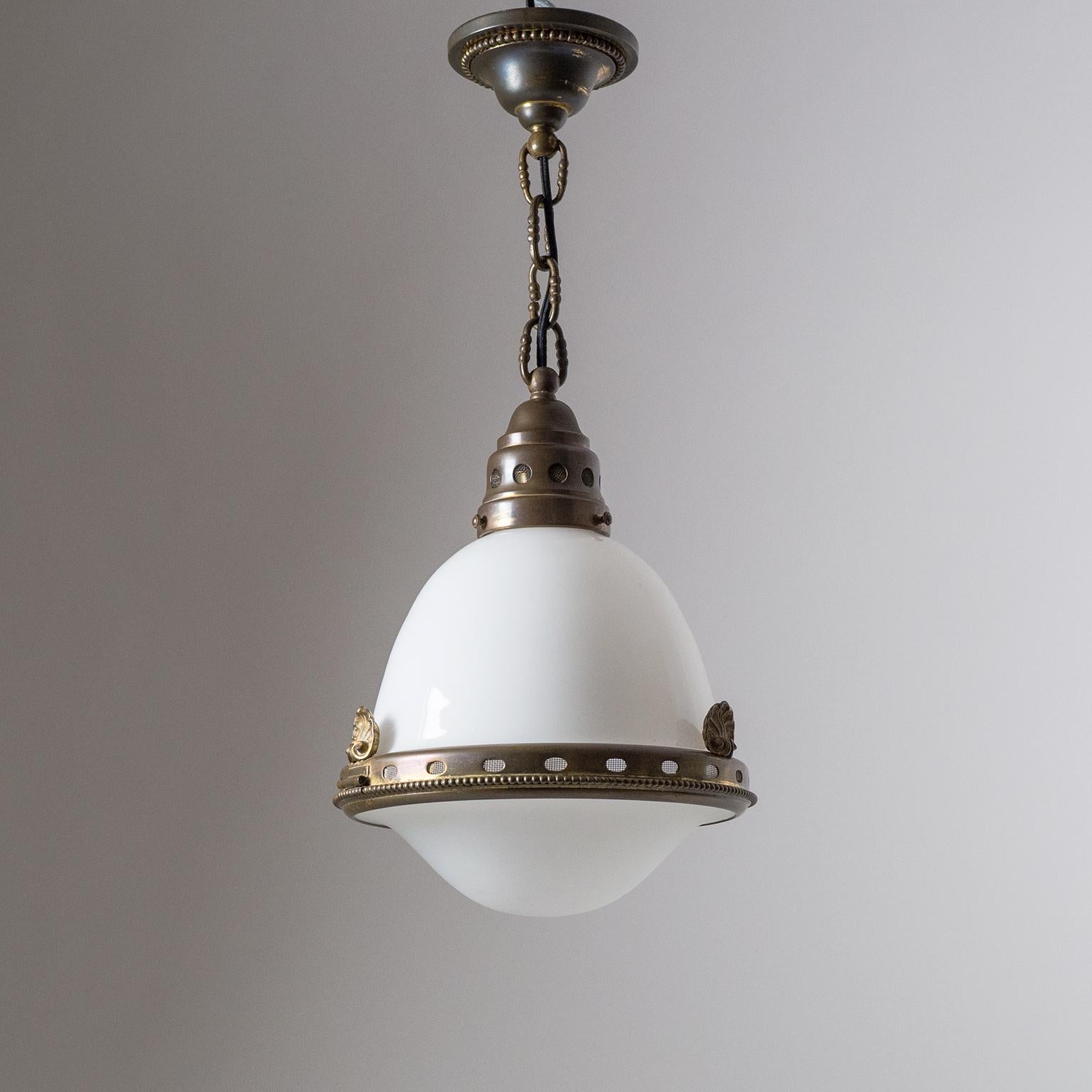 Very fine early 1900s Austrian pendant or lantern. Very intricately worked brass elements with lots of attention to detail. The diffuser is composed of two blown glass parts: The upper is glossy with a white inner casing, and the bottom is