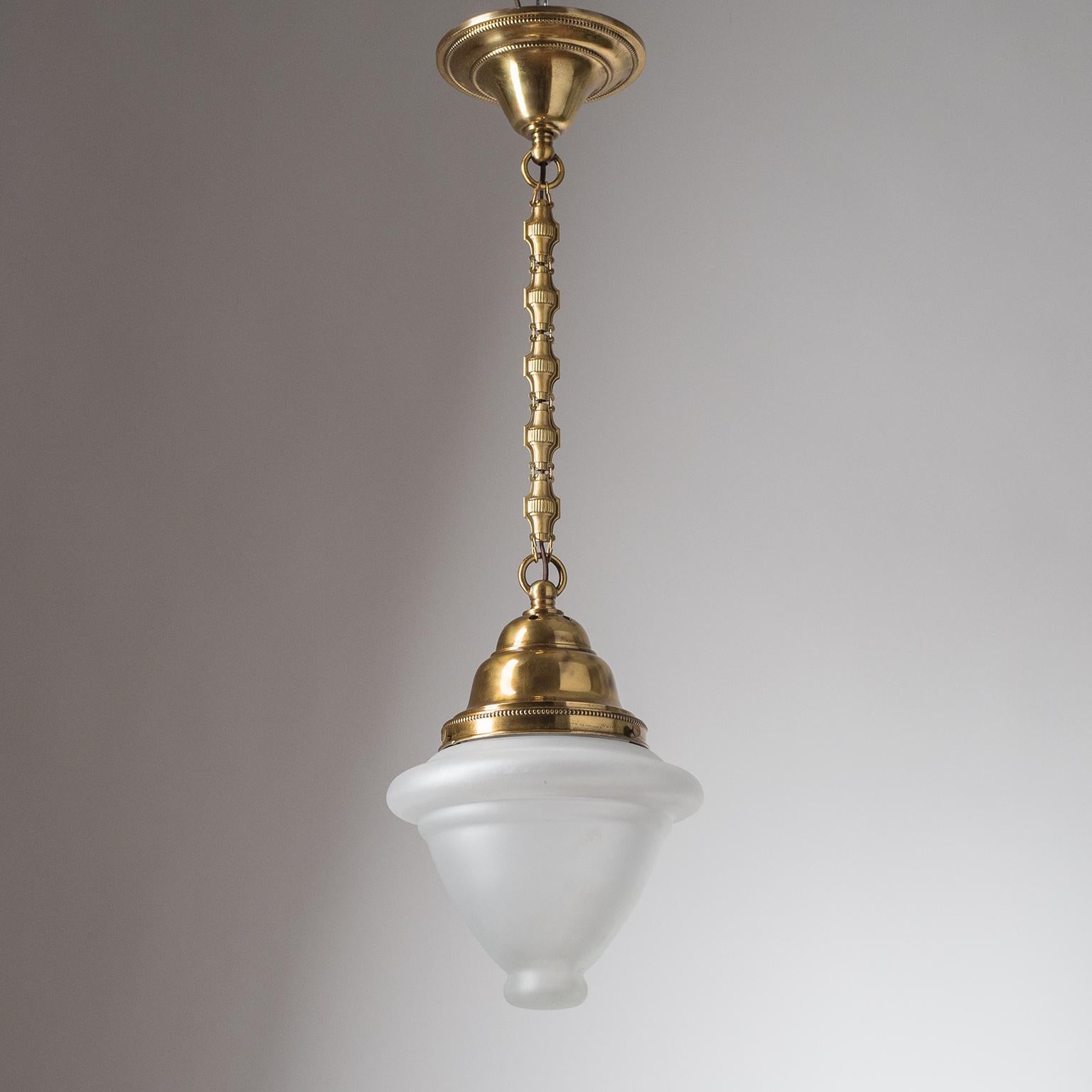 Fine Austrian brass pendant from the 1910-1920s. Clear glass diffuser with a satin finish on the outside. One original brass and ceramic E27 socket with new wiring. Height without chain is approximately 15inches/38cm.
