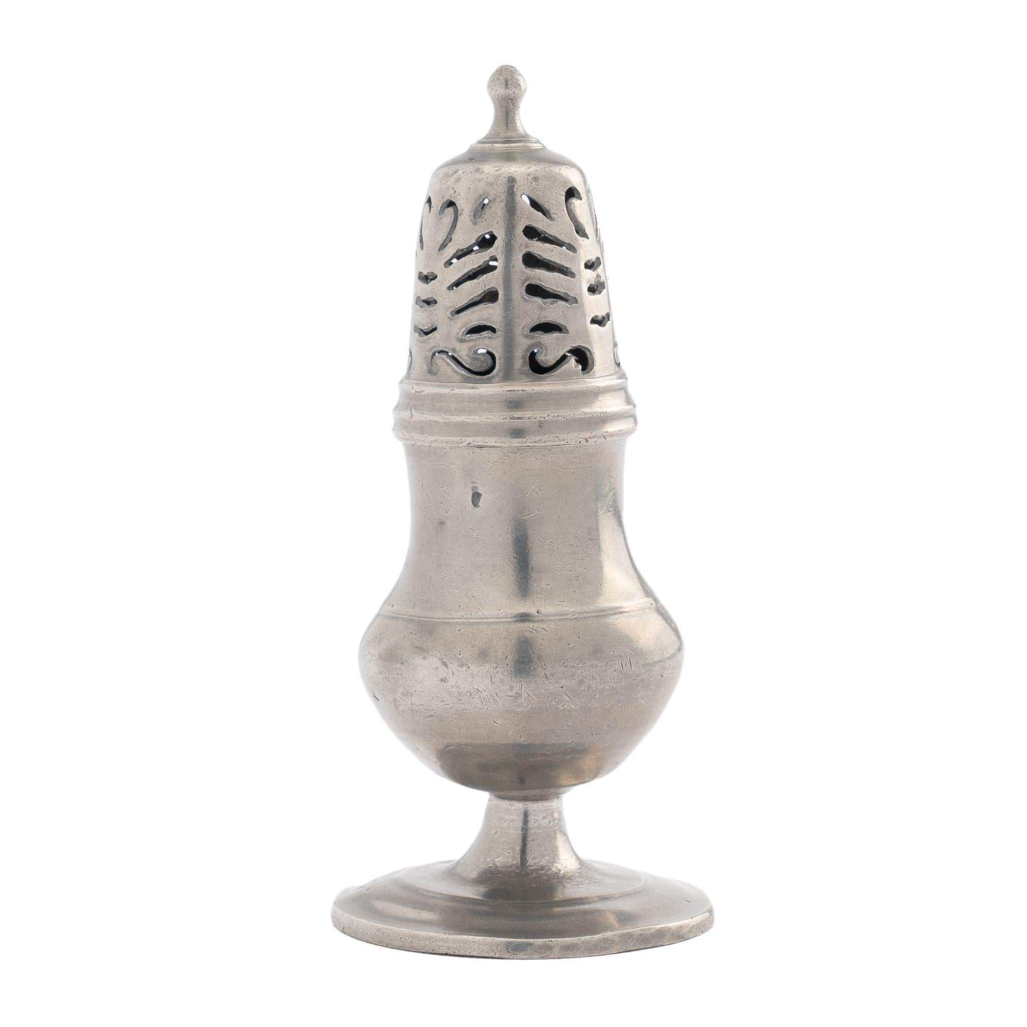 Pewter sugar castor with a Neoclassic anthemion pierced lid, threaded to a pyriform vessel on circular foot.
Austria, circa 1830.