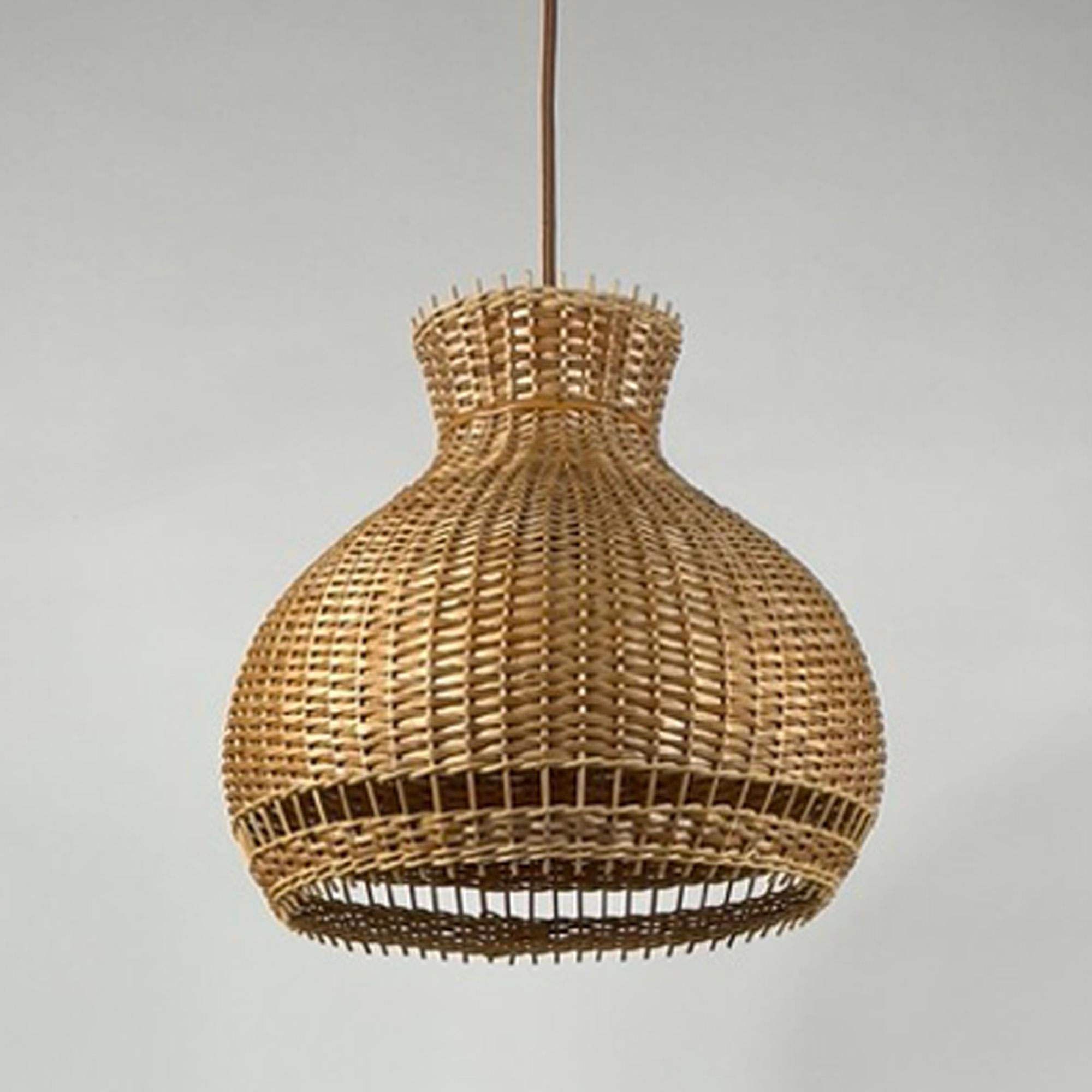 This beautiful handcrafted pendant was designed and manufactured in Austria in the 1950s to 1960s. It features a large rattan lampshade with light brown silk cord and brass canopy. The canopy is new and any other canopy can be chosen.

The light has