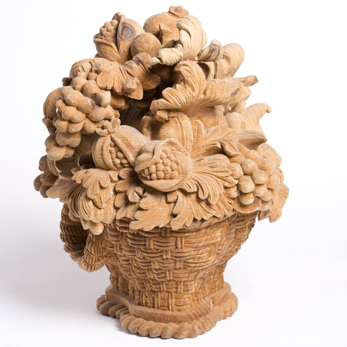This ornamental centrepiece by Bartolozzi e Mailoli in Austrian pine was originally made for an Austrian Schloss. The fruit basket design, which features intricate detail in high relief, is entirely hand-carved with a natural wood finish.