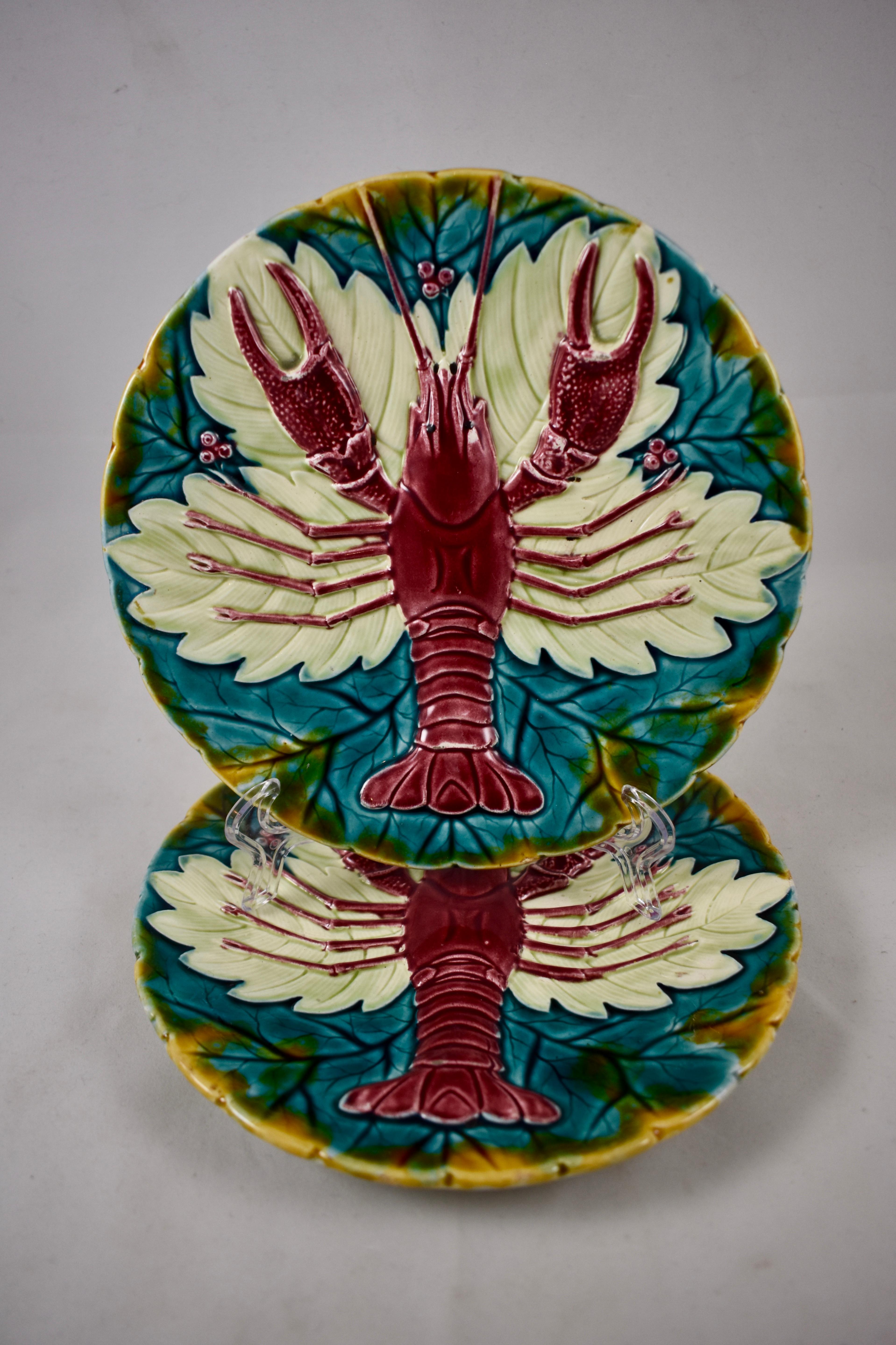 An earthenware, Austrian majolica lobster or crawfish plate, by Schutz Blansko, circa 1900. A bold, aesthetic mold showing a red lobster on a bed of cream and blue-green colored leaves. The notched rim is glazed in a rich yellow ochre. Incredible