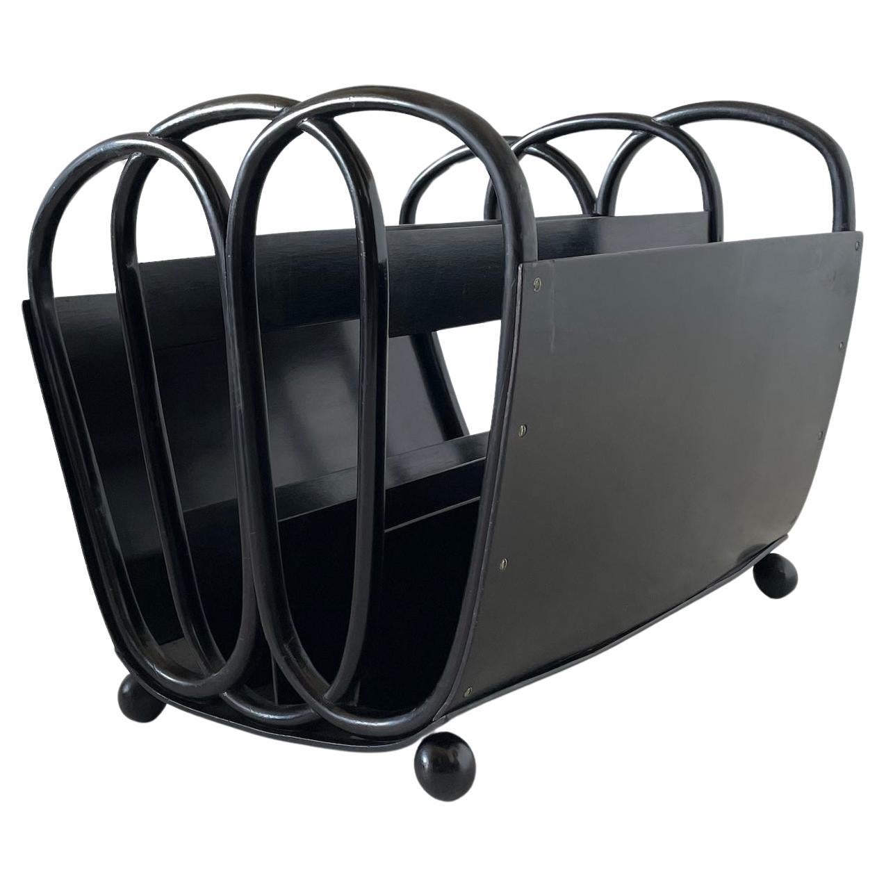 Austrian Secession beech magazine rack 

Polished black bentwood set on ball feet

Designed by Koloman Moser

Executed by Jacob and Josef Kohn

Remnants of a label to underneath 

Model No 1070

Circa 1901

A similar magazine rack with a square
