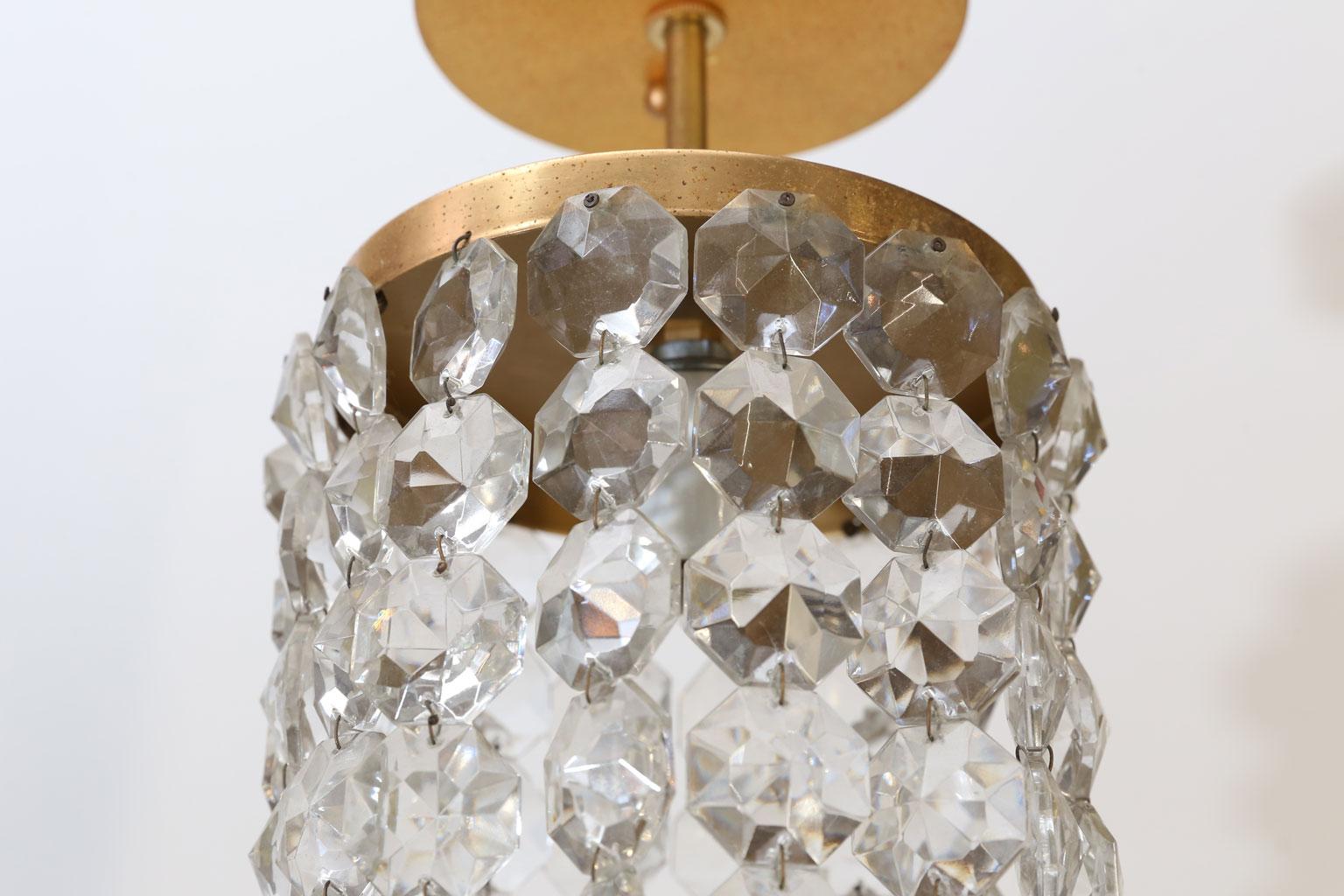 Austrian single light flush mount (circa 1950s) accommodates an Edison (medium-base) bulb. Gilded brass body decorated in chains of crystal. Newly wired for use within the USA using all UL listed parts.
