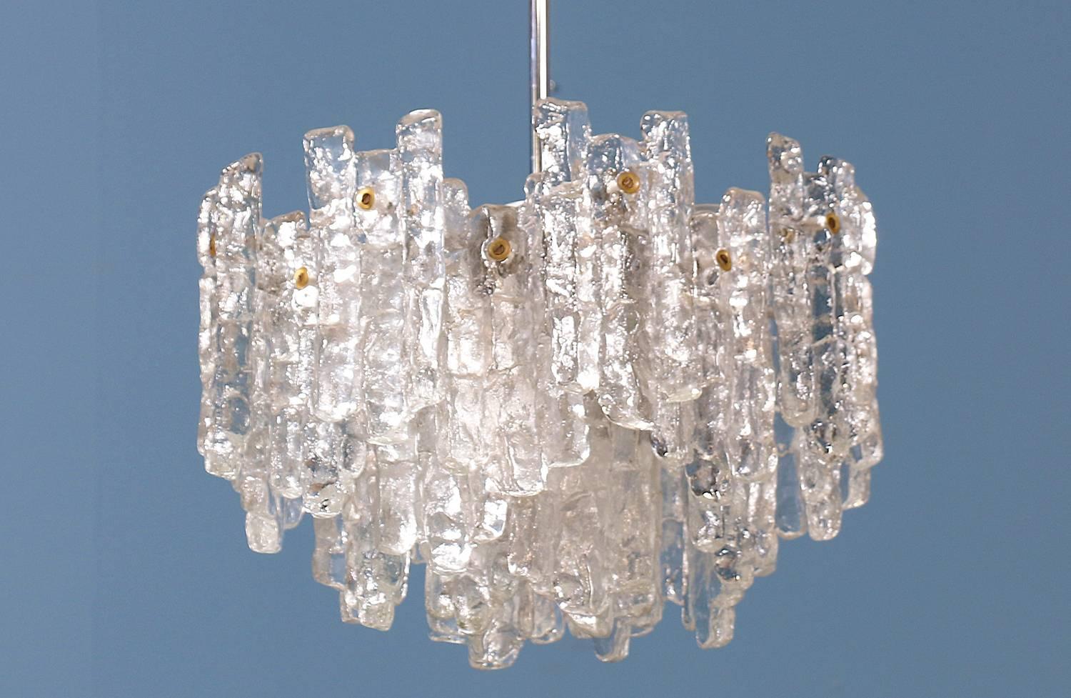 Mid-century Austrian Chandelier designed by Julius Theodore Kalmar and manufactured by Kalmar for the Soria collection circa 1960’s. This spectacular chandelier features icicle-like glass components that make up the shade. Nine light bulbs refract