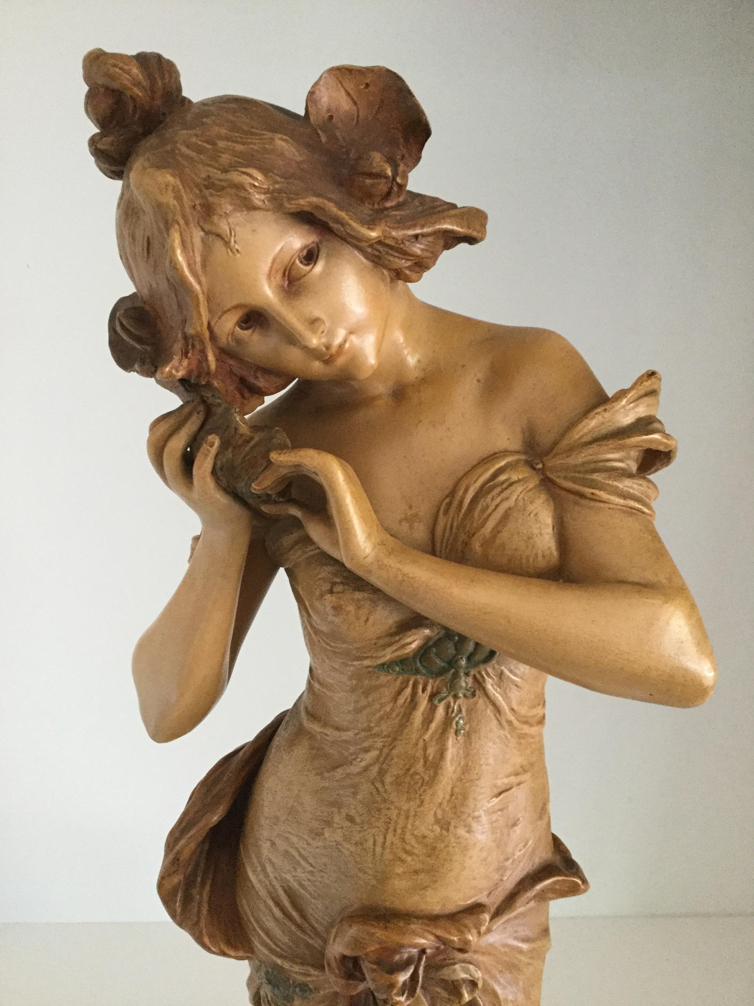 An Austrian Ernst Wahliss Art Nouveau figurine, circa 1880

Ernst Wahliss (1837-1900), Austrian Art Nouveau ceramic sculptural figure of a semi draped maiden listening to a shell, modeled in a long cascading robe with golden tones and highlights