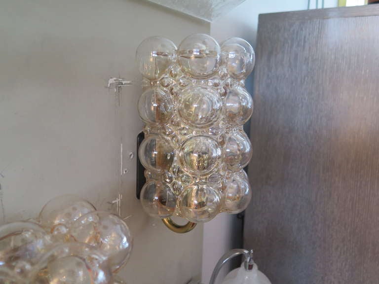 Great pair of cylindrical shaped Austrian bubble glass sconces with brass hardware. Slight amber tint to glass. Newly rewired.
